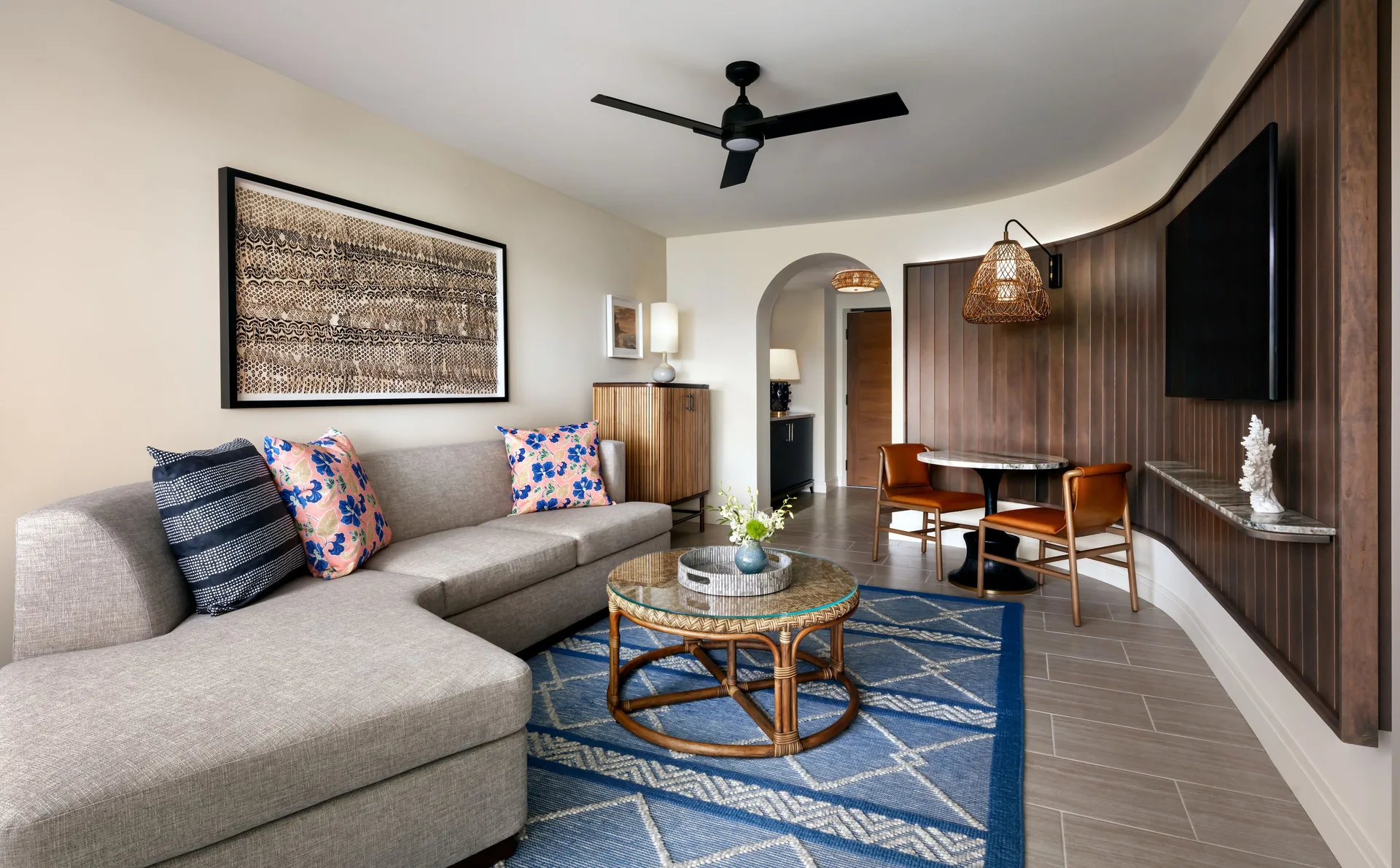 Fairmont Kea Lani Maui living room with sectional sofa, dining table and TV at Fairmont Kea Lani Maui.