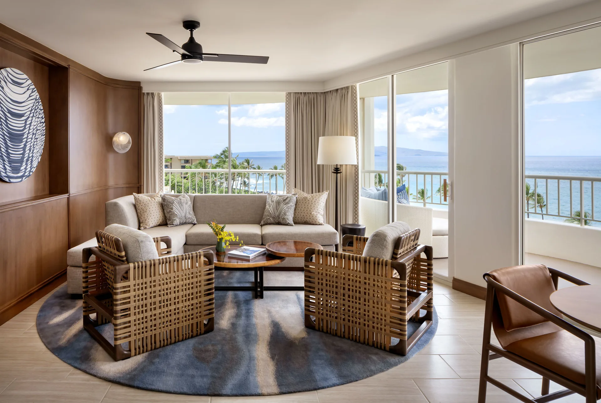 Kilohana Corner Suite living room with ocean-facing windows at Fairmont Kea Lani Maui.