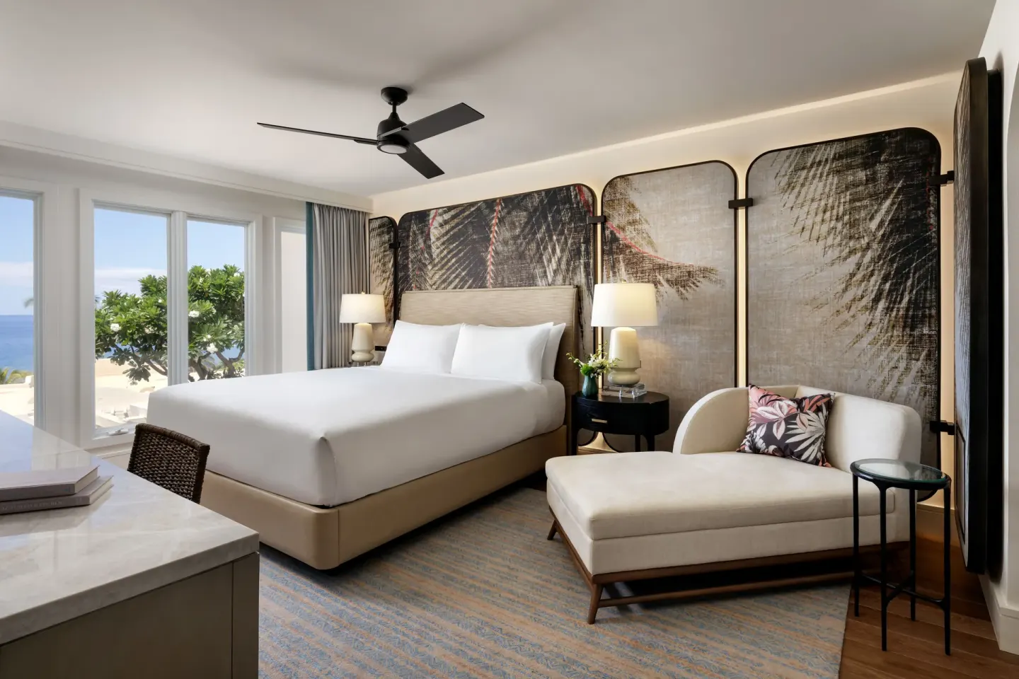 Ocean-view king bedroom in a luxury villa at Fairmont Kea Lani Maui with a chaise and large windows.