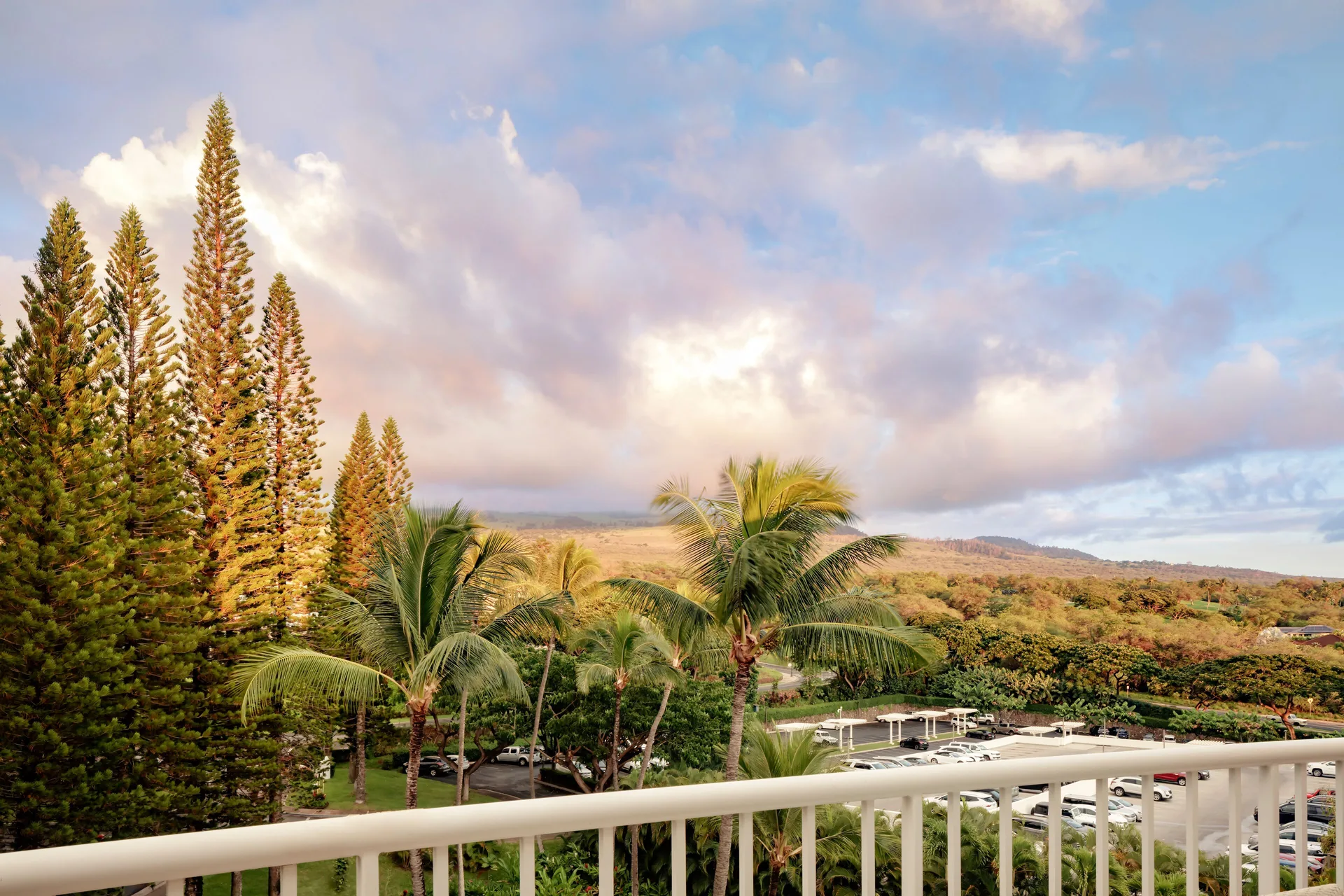 Mountainside suite balcony view with palms and hills at Fairmont Kea Lani Maui.