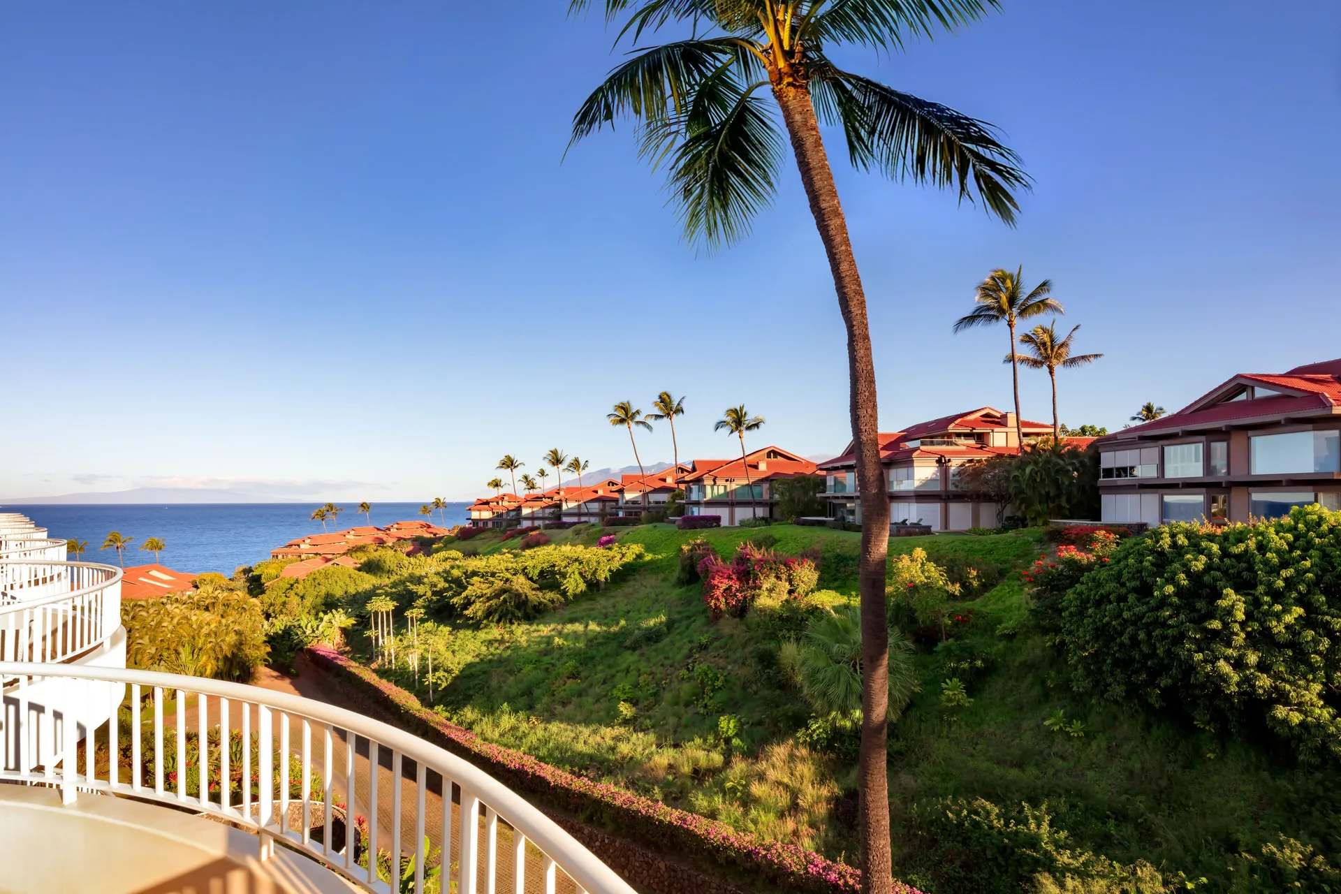 Partial Ocean View Suite balcony facing palms, gardens, and ocean at Fairmont Kea Lani Maui.