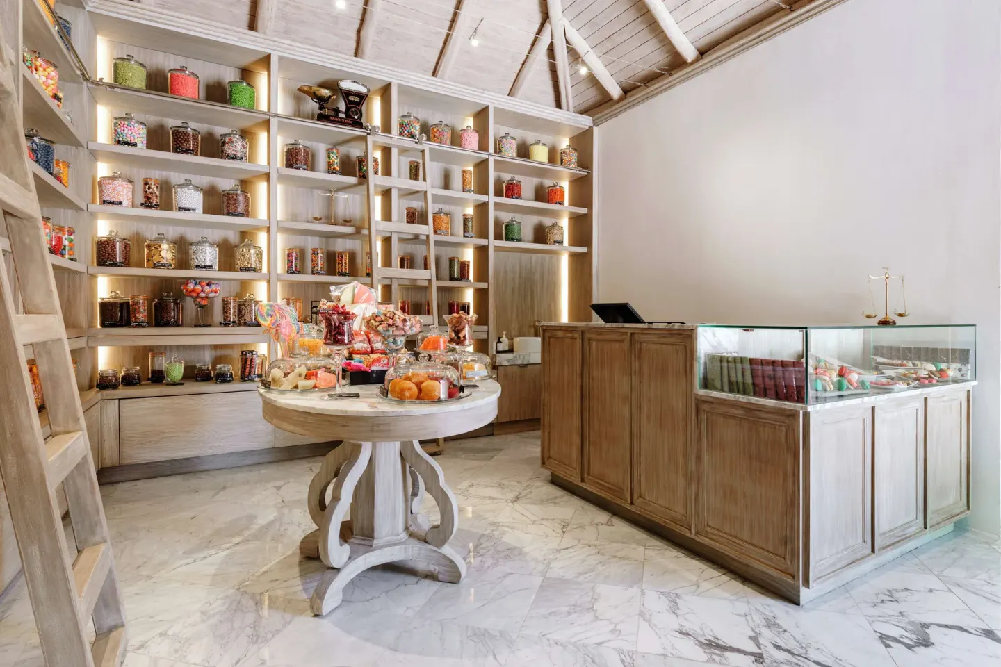Candy shop with glass jars, display cases, and wood shelving at Fairmont Mayakoba.