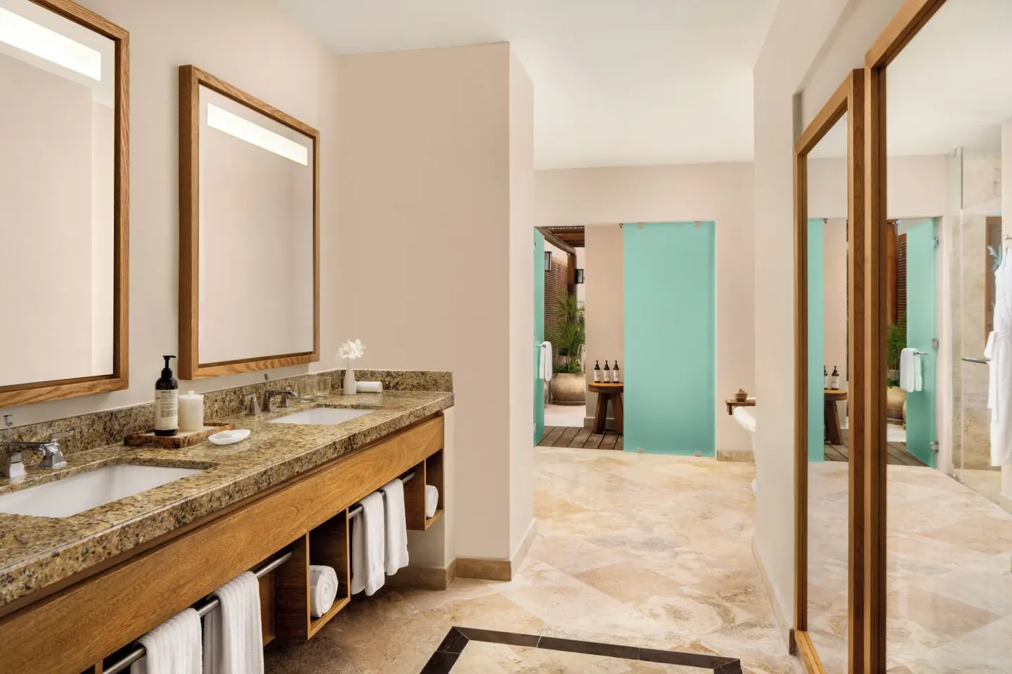 Bambu Suite bathroom with double vanity and glass shower area at Fairmont Mayakoba.