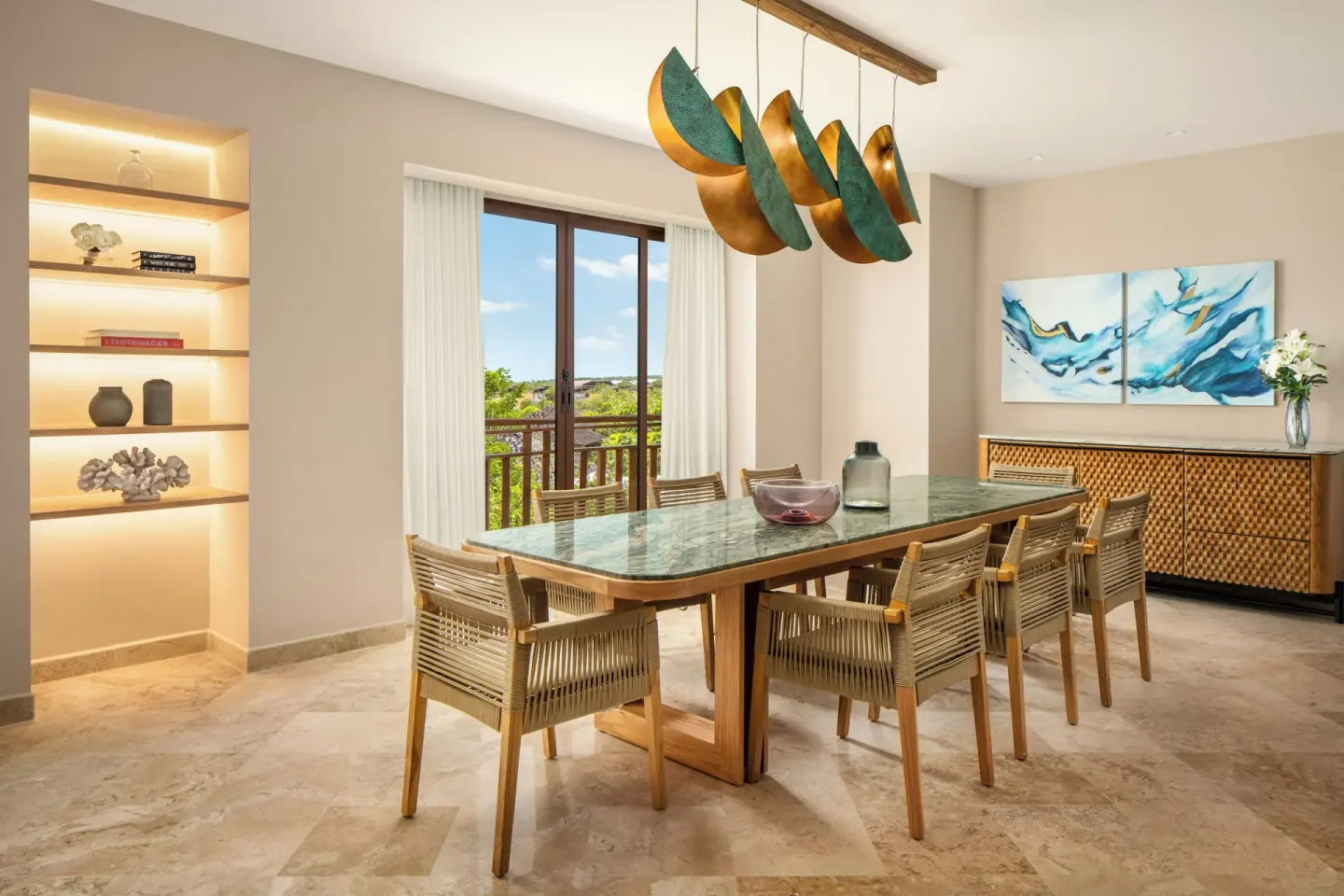 Bambu Suite dining area with glass-top table and balcony doors at Fairmont Mayakoba.