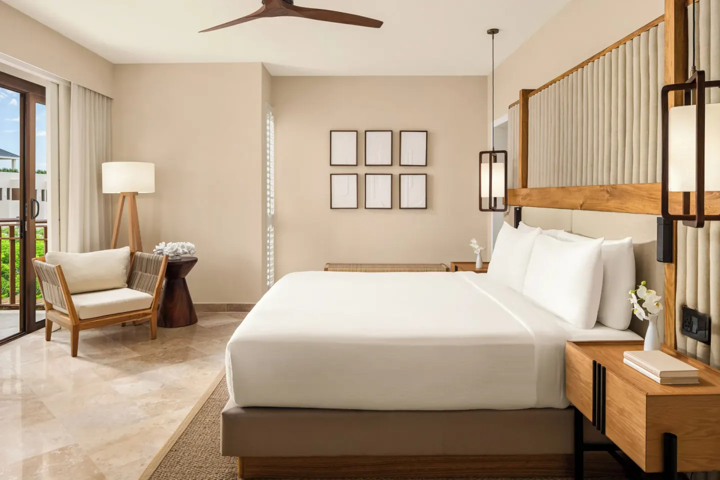 Bambu Suite bedroom with king bed and balcony seating at Fairmont Mayakoba.