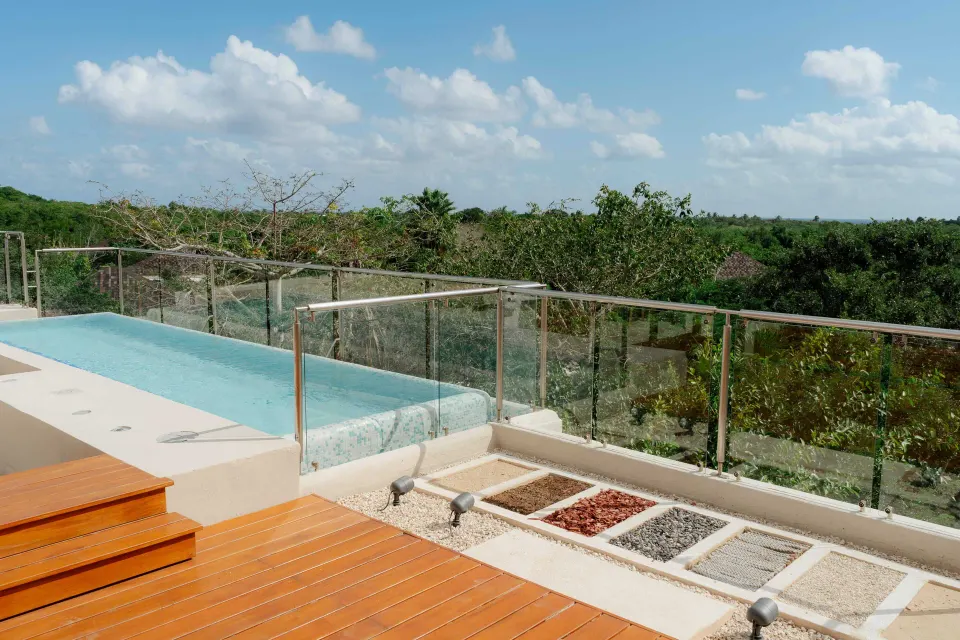 Bambu Suite private pool edge and glass railing overlooking greenery at Fairmont Mayakoba.