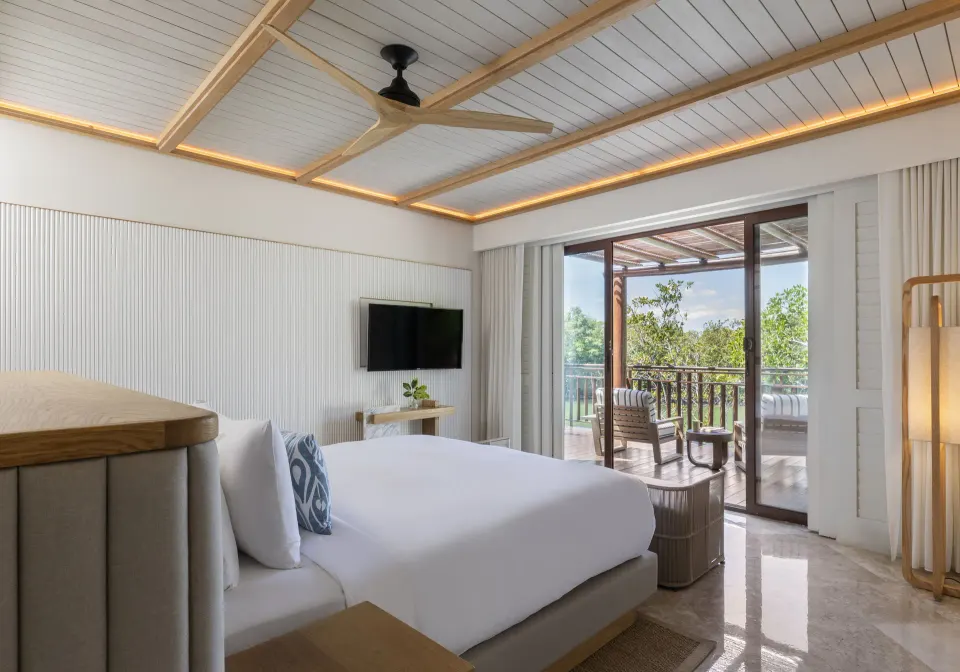 King bed opening to a furnished terrace in a Beach Area Casita Suite at Fairmont Mayakoba.