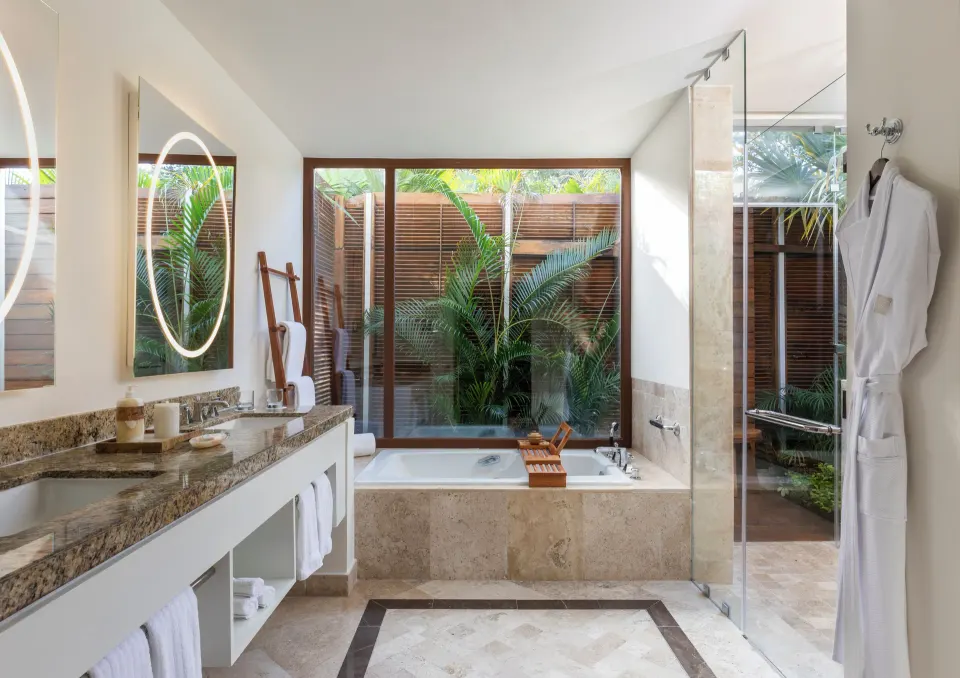 Beachfront Casita bathroom with soaking tub and glass shower at Fairmont Mayakoba.