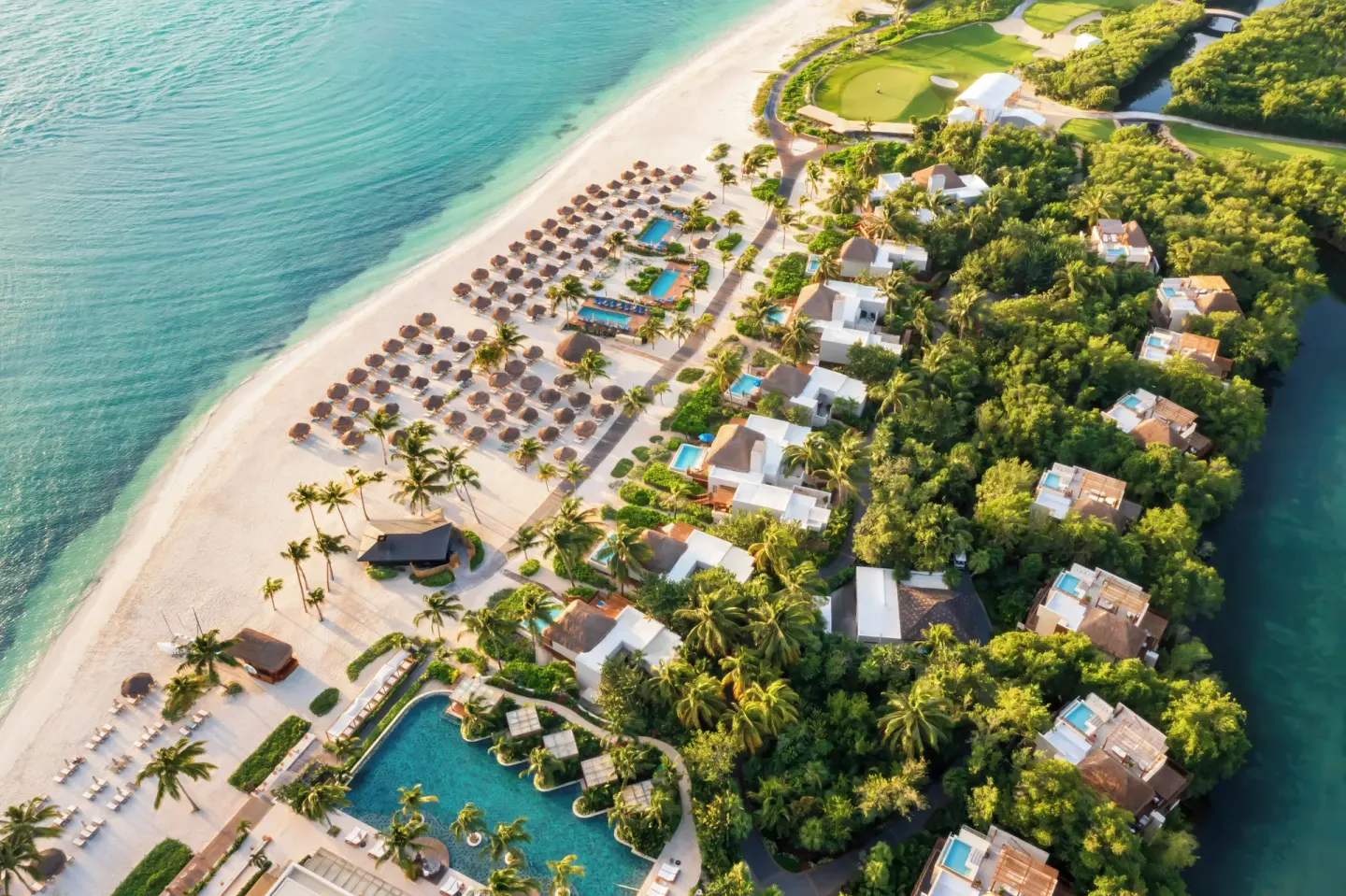 Aerial view of beachfront casitas and private paths beside the beach at Fairmont Mayakoba.