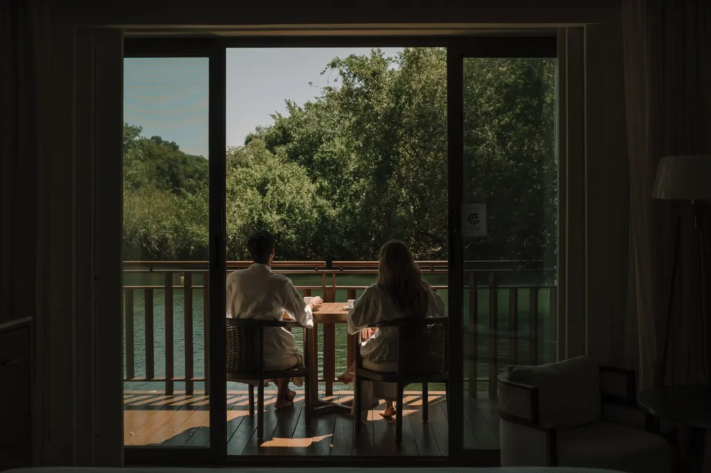 Casita Signature Room balcony at Fairmont Mayakoba with two guests seated by the water.