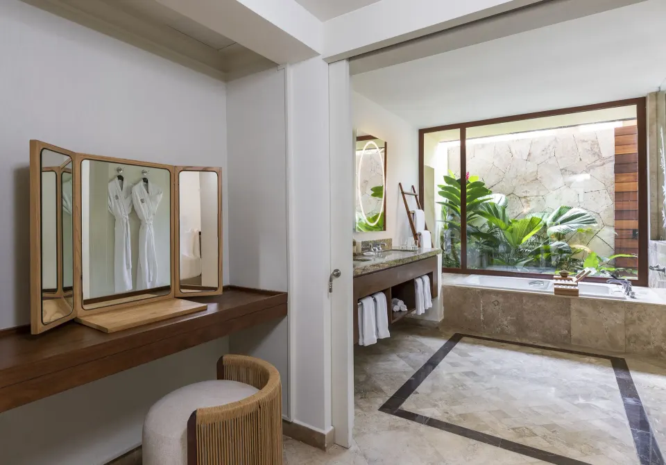 Casita Signature suite bathroom with vanity, tub, and dressing area at Fairmont Mayakoba.