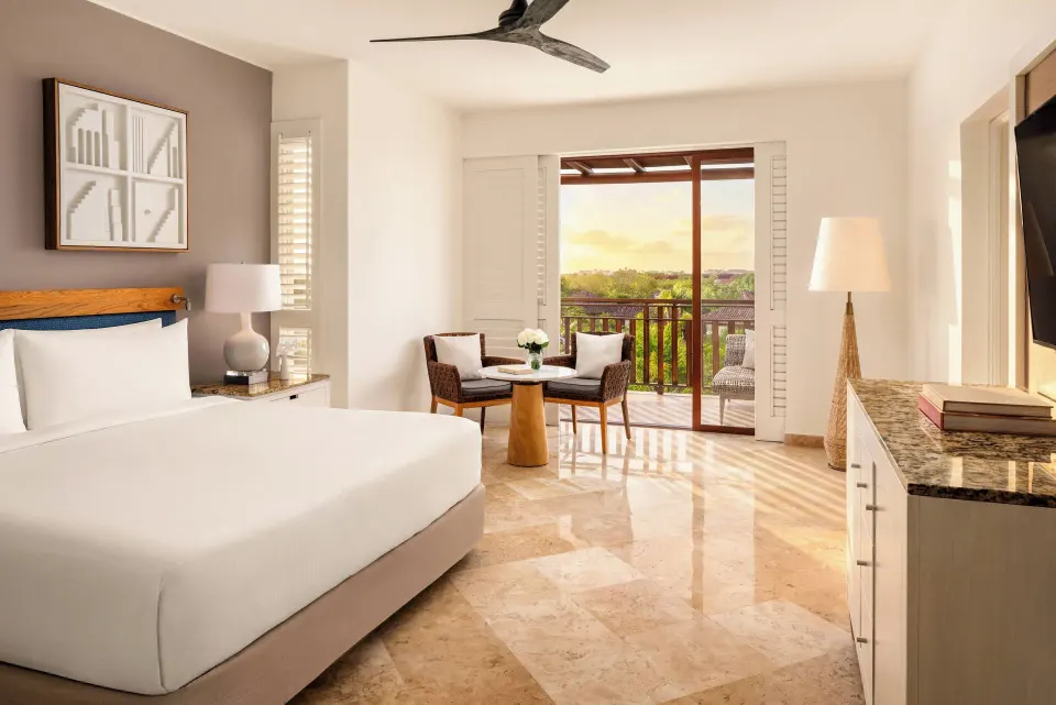 Fairmont Mayakoba at Fairmont Mayakoba with a king bed, seating area, TV console, and balcony doors.