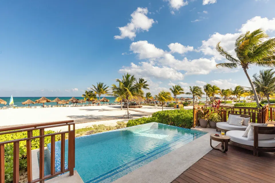 Beachfront terrace with plunge pool, daybed, palms and ocean at Fairmont Mayakoba.