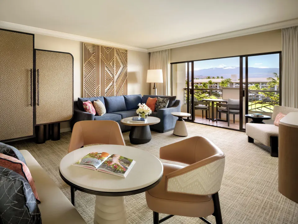 Living area of an ocean view one-bedroom suite at Fairmont Orchid with balcony seating.