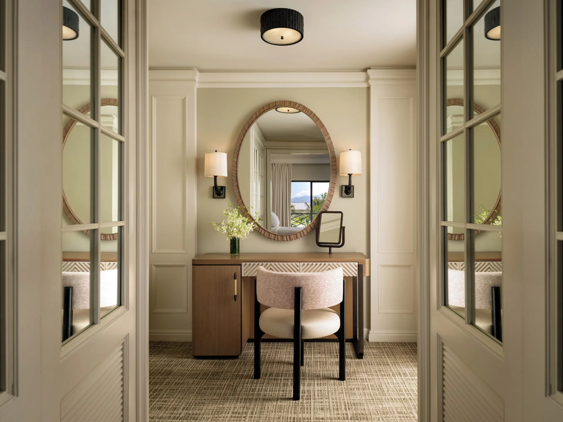 Vanity desk in a Fairmont Orchid ocean view one-bedroom suite framed by glass doors.