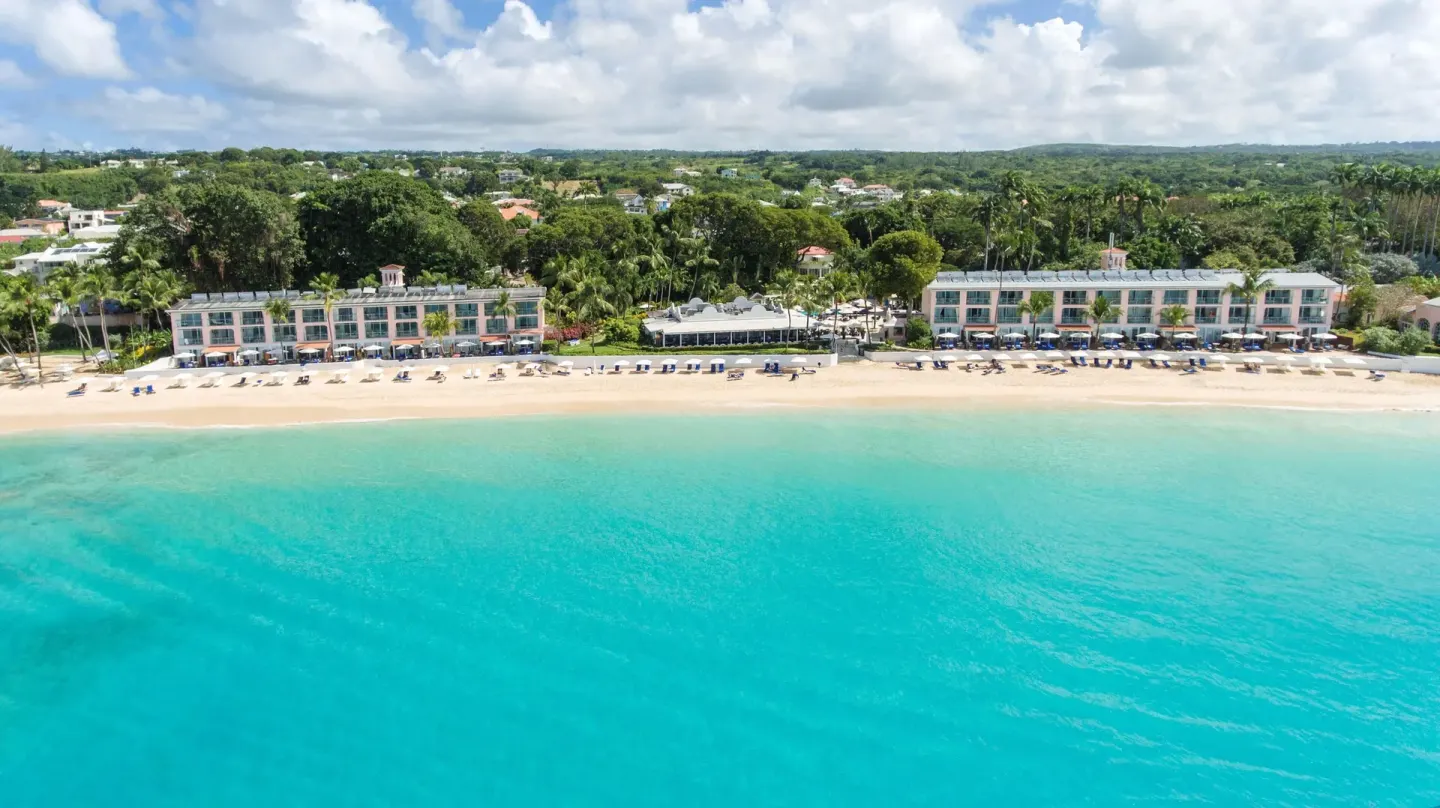 Aerial beachfront view of the resort and turquoise sea at Fairmont Royal Pavilion.