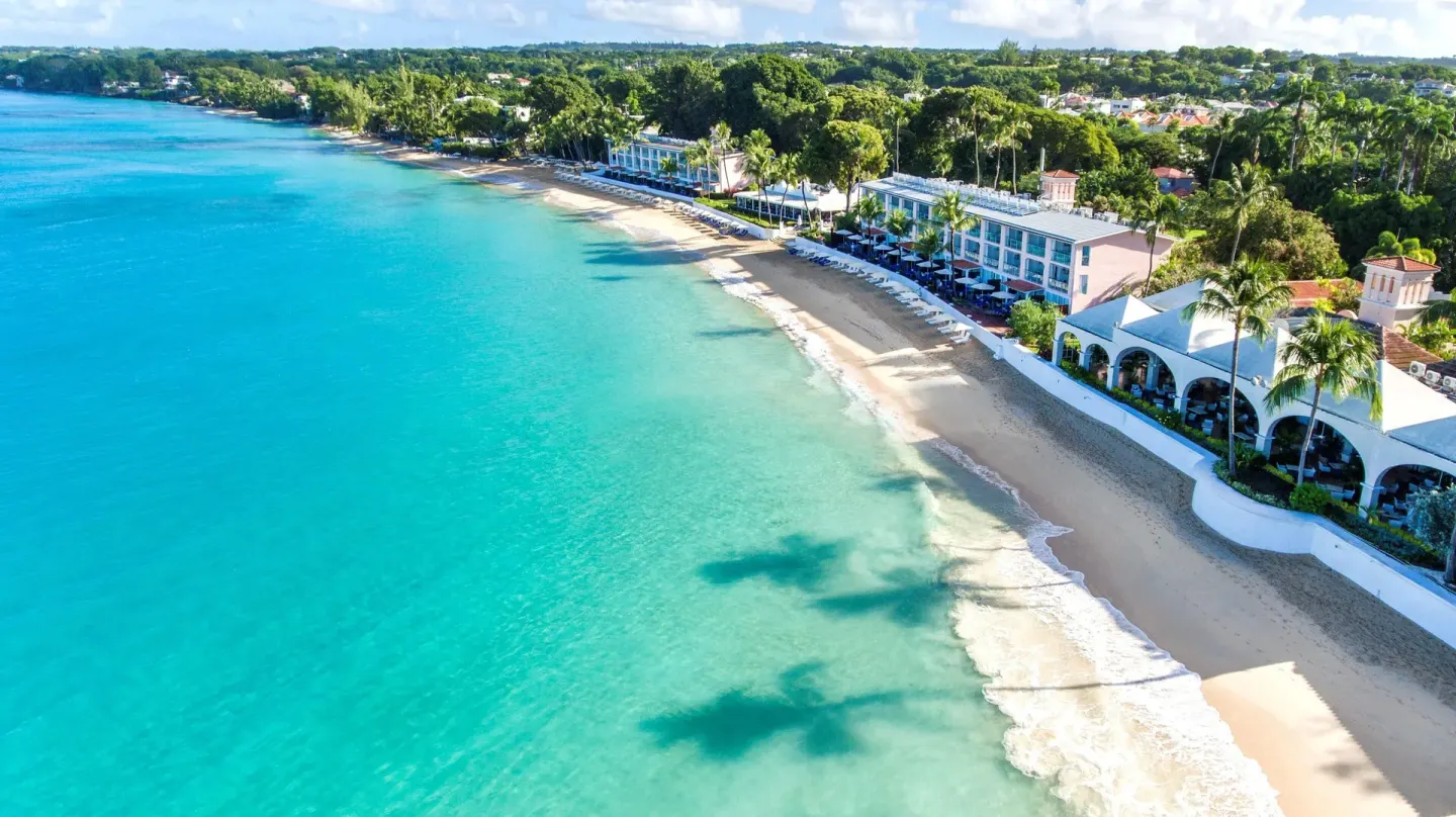 Aerial view of the beachfront and turquoise water at Fairmont Royal Pavilion.