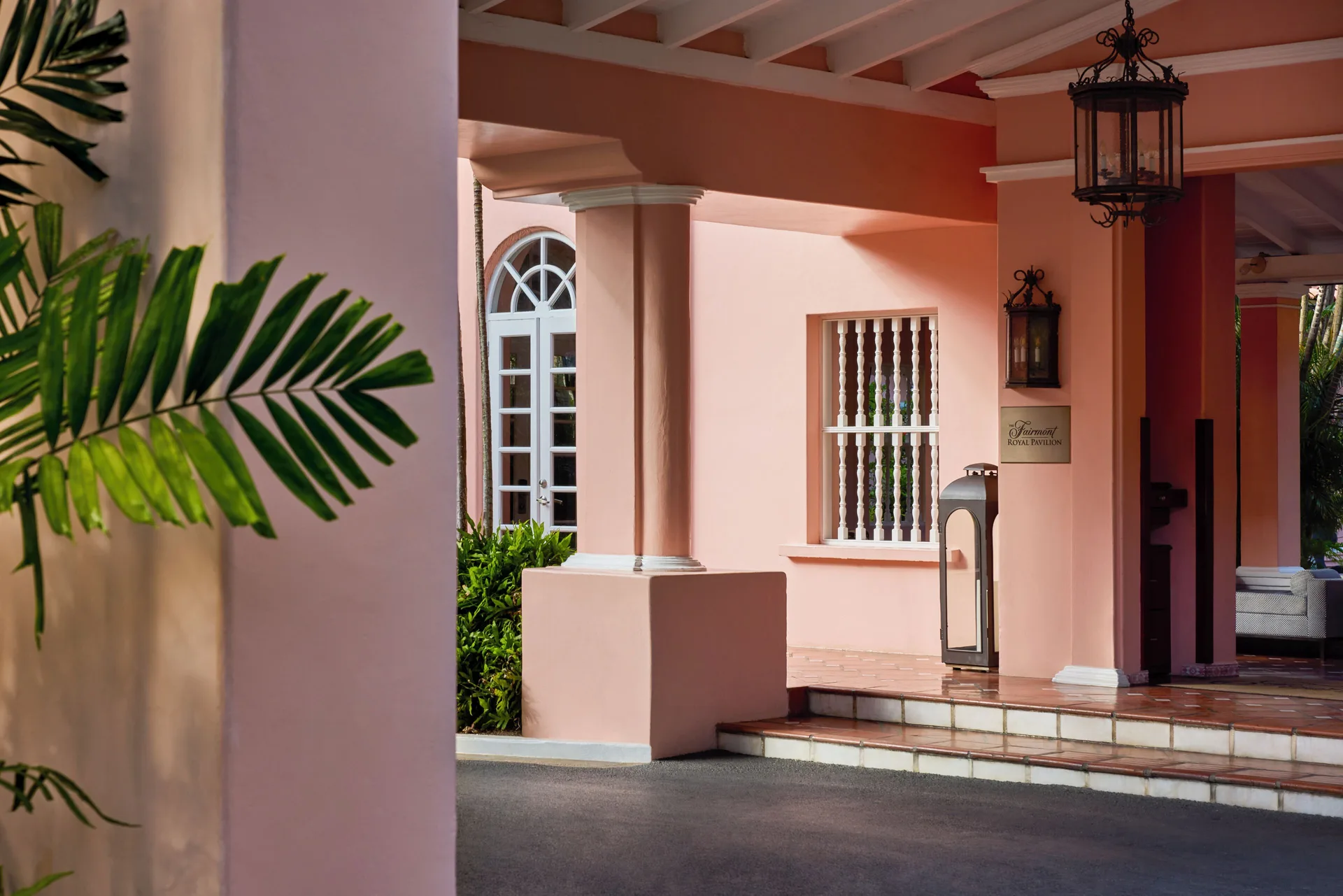 Covered pink entrance with lanterns and signage at Fairmont Royal Pavilion.