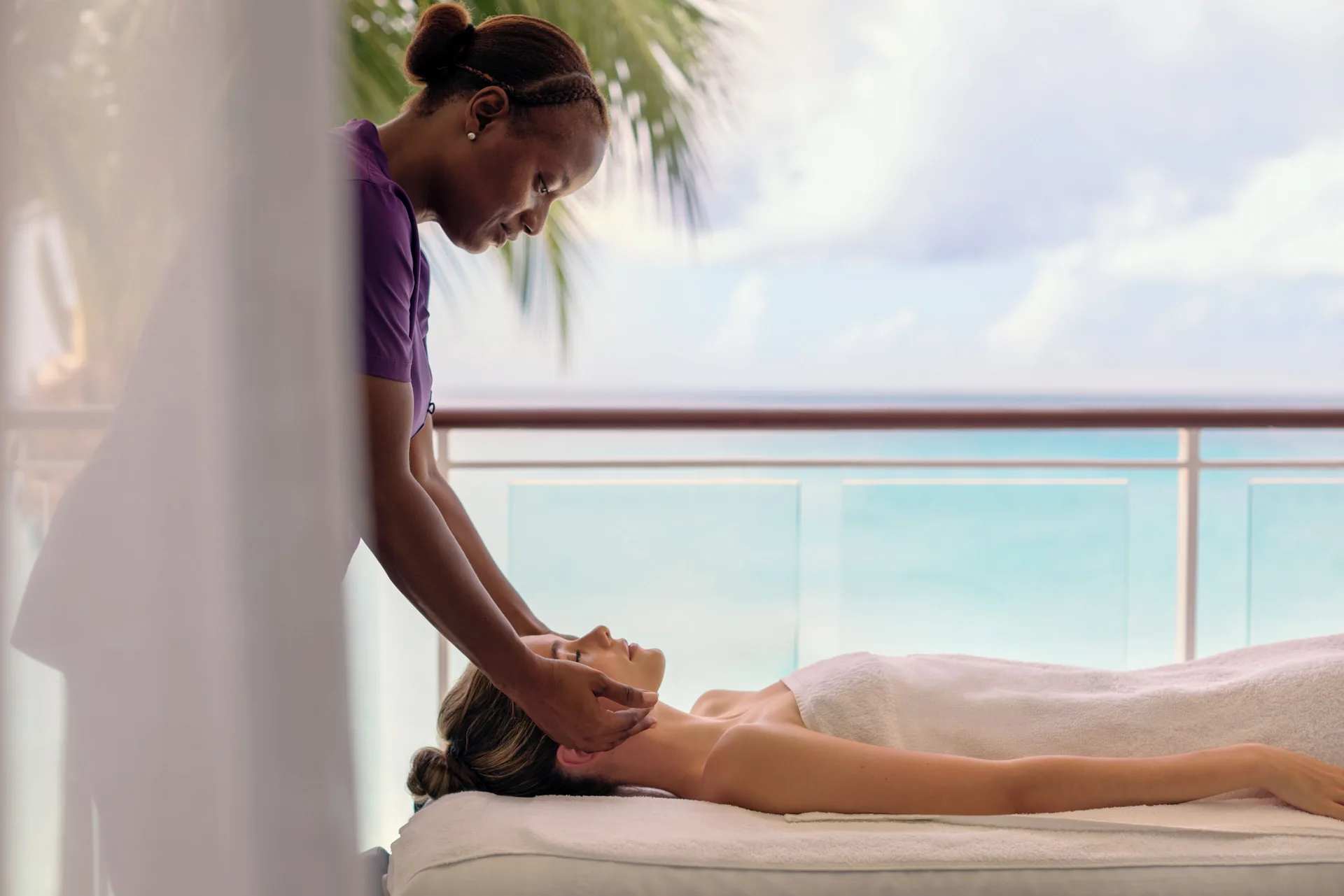 Massage treatment beside an ocean-view balcony at Fairmont Royal Pavilion.