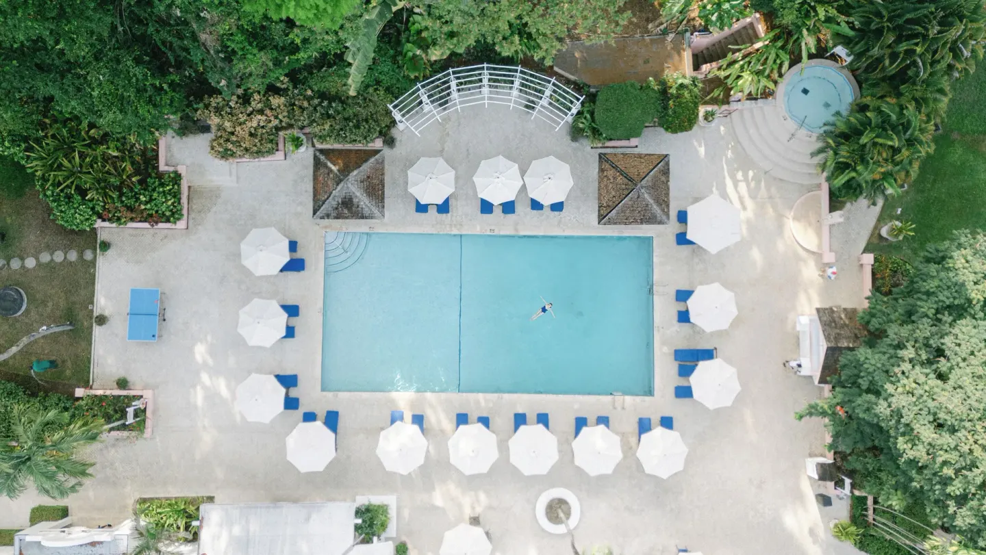 Overhead view of the pool deck with umbrellas at Fairmont Royal Pavilion.