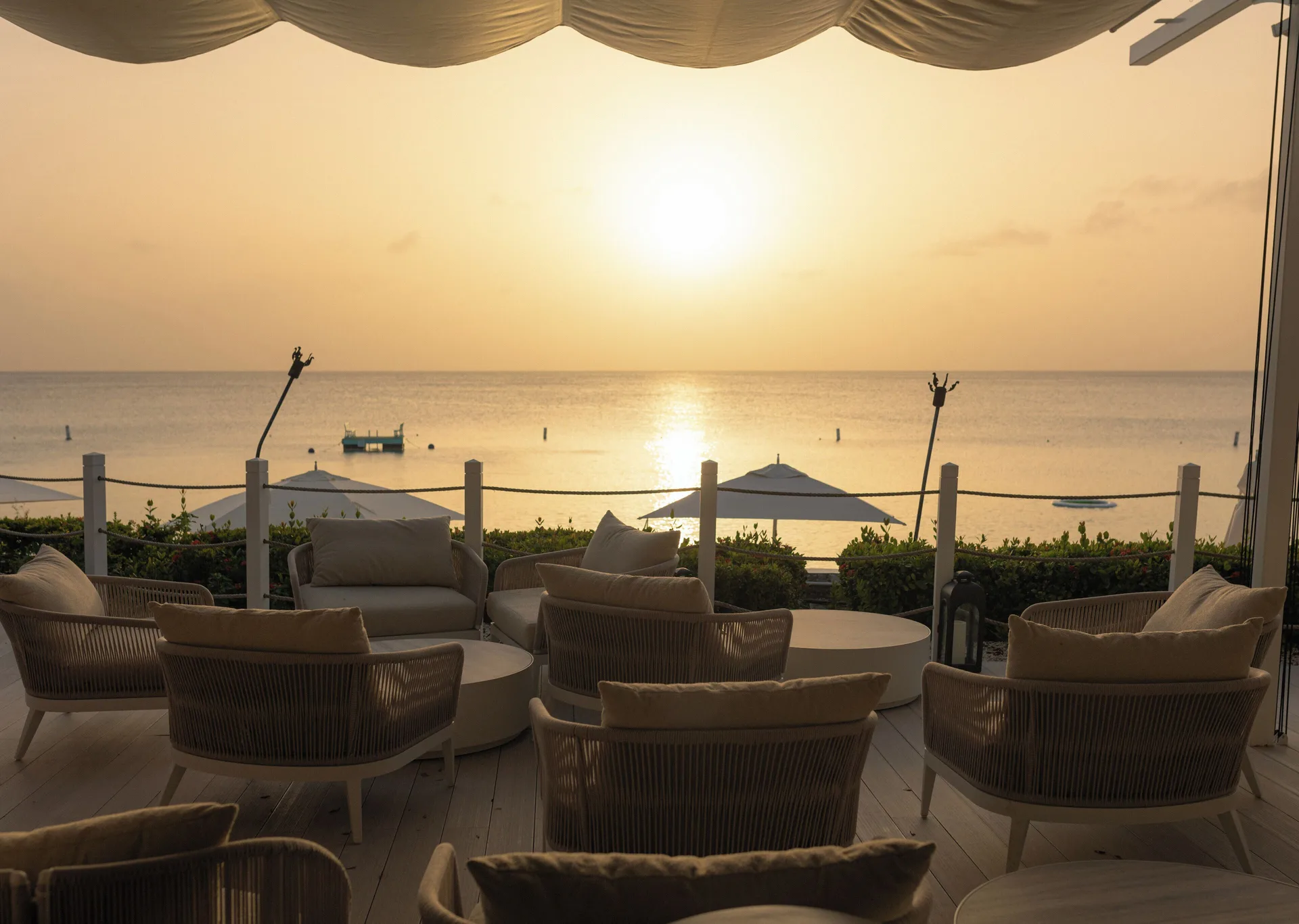 Lounge seating facing the sunset over the sea at Fairmont Royal Pavilion.