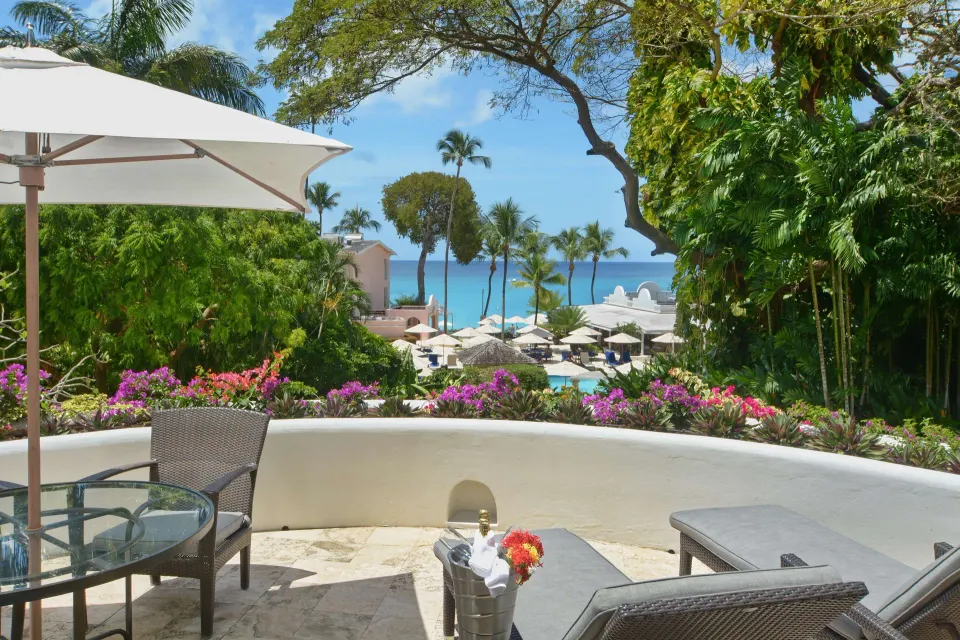 Junior Suite terrace with garden, pool, and sea view at Fairmont Royal Pavilion.