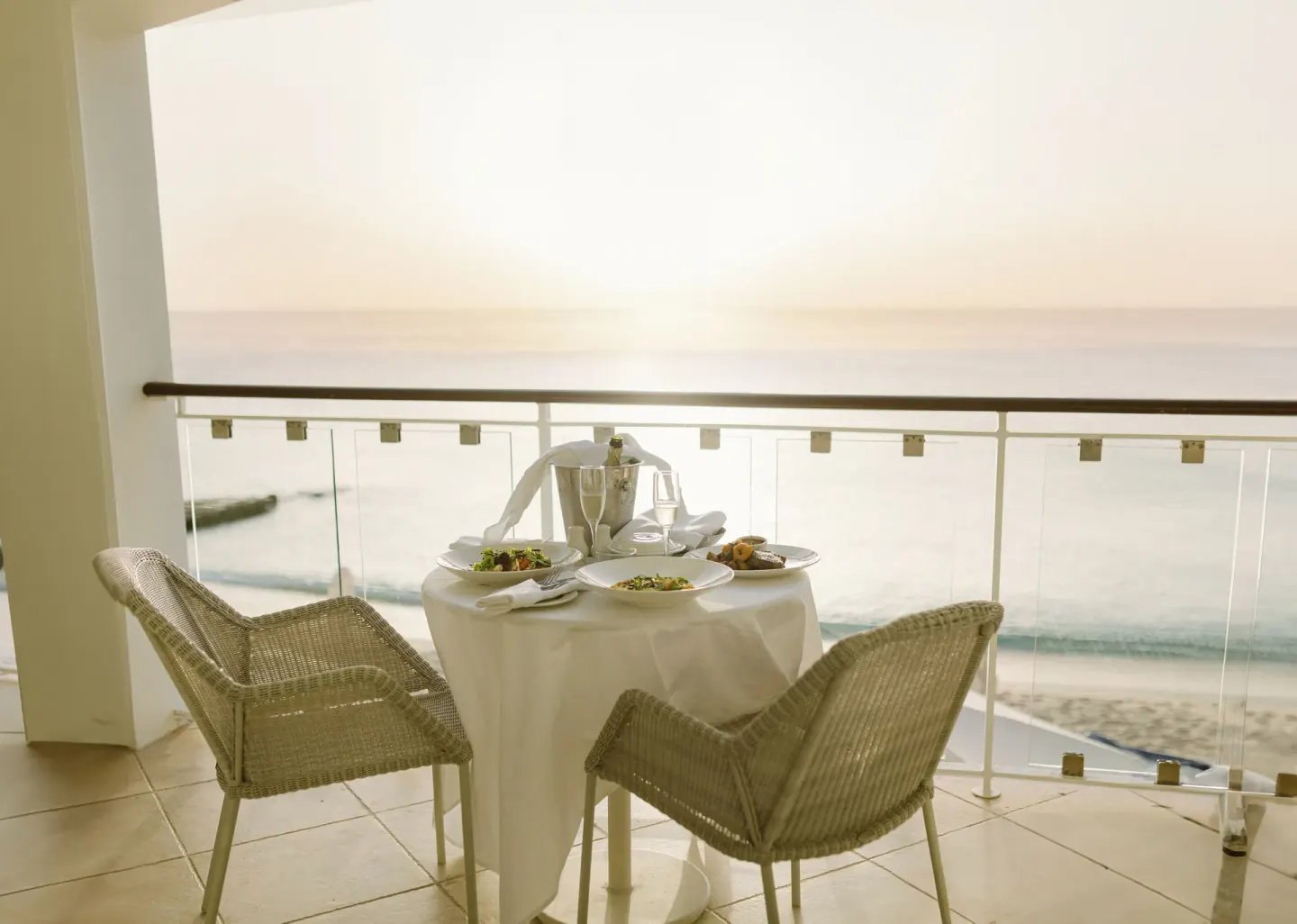 Luxury Room Oceanfront balcony dining table overlooking the sea at Fairmont Royal Pavilion.