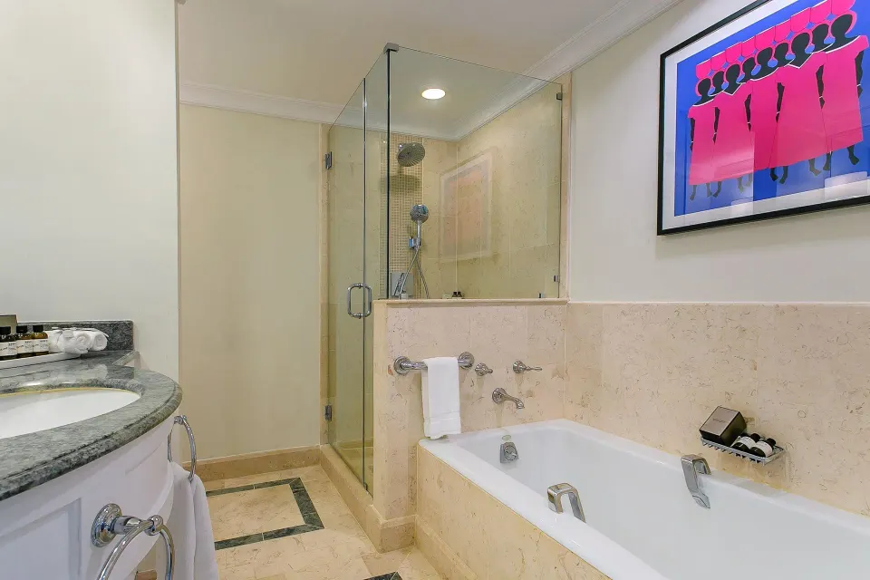 Luxury Room Oceanfront bathroom with tub and glass shower at Fairmont Royal Pavilion.