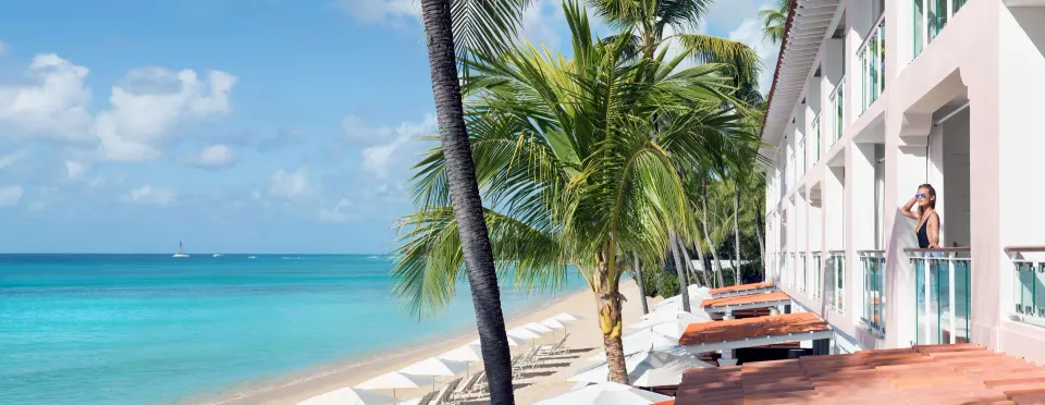 Oceanfront guest room balconies above the beach at Fairmont Royal Pavilion.