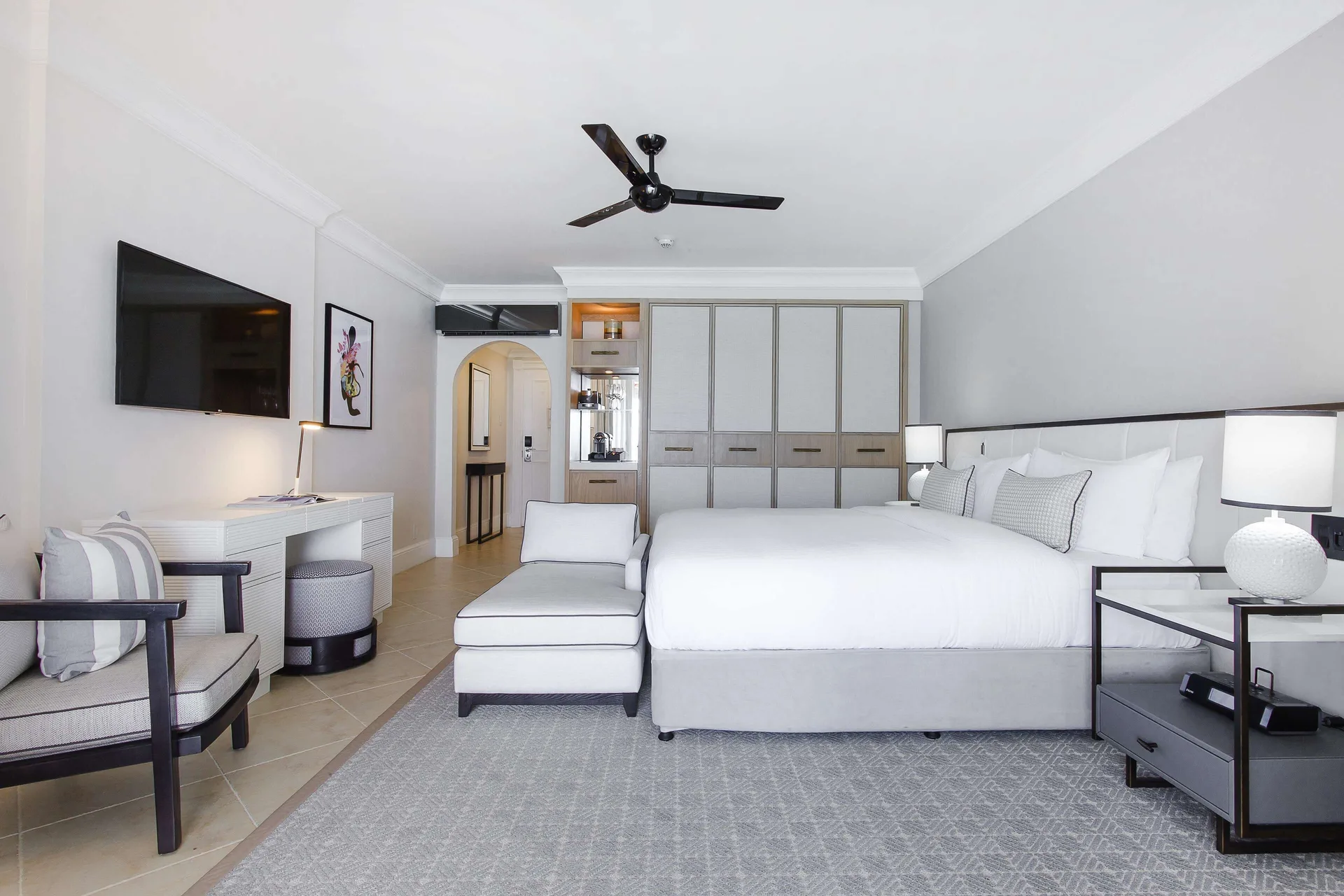 Luxury Room Oceanfront with king bed, chaise, desk and wall TV at Fairmont Royal Pavilion.