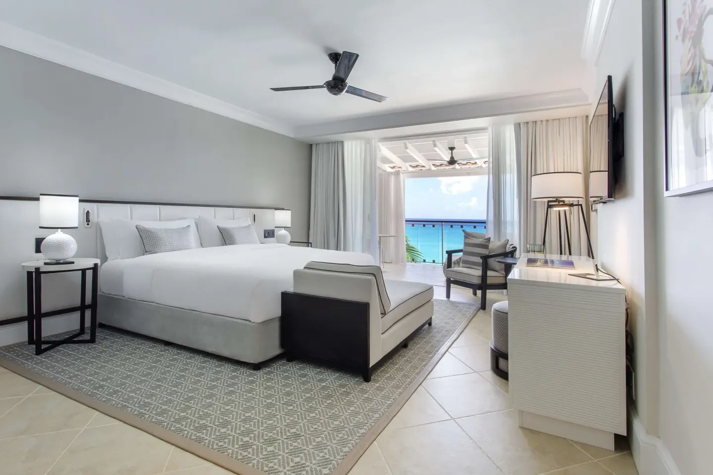 Signature Room oceanfront king bed and balcony view at Fairmont Royal Pavilion.