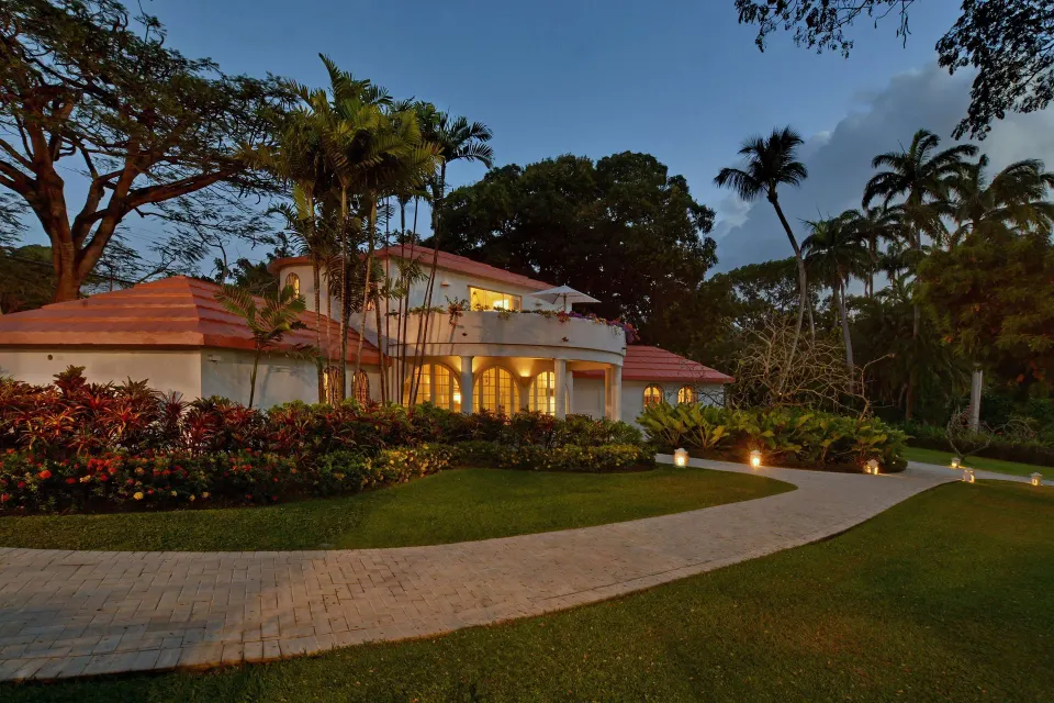 Two-bedroom suite building and garden path at dusk at Fairmont Royal Pavilion.