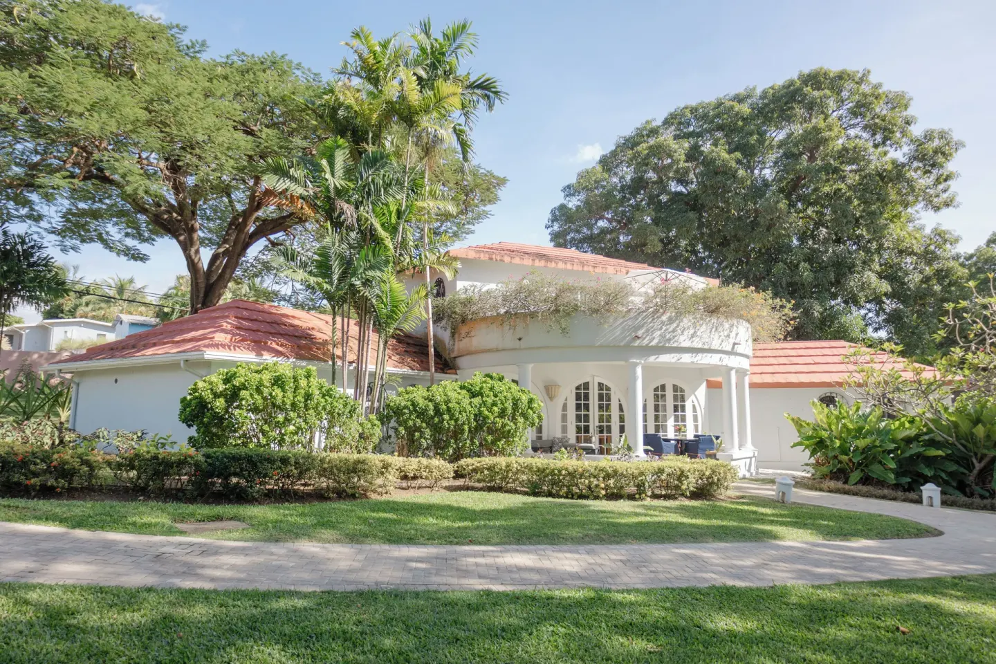 Two-bedroom suite exterior with lawns and tropical trees at Fairmont Royal Pavilion.