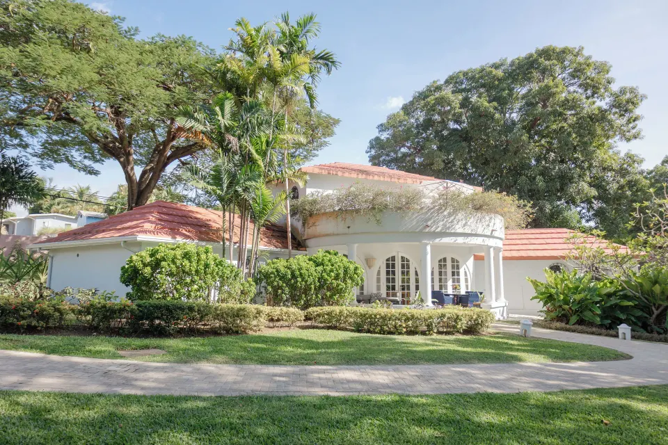 Two-bedroom suite exterior with lawns and tropical trees at Fairmont Royal Pavilion.
