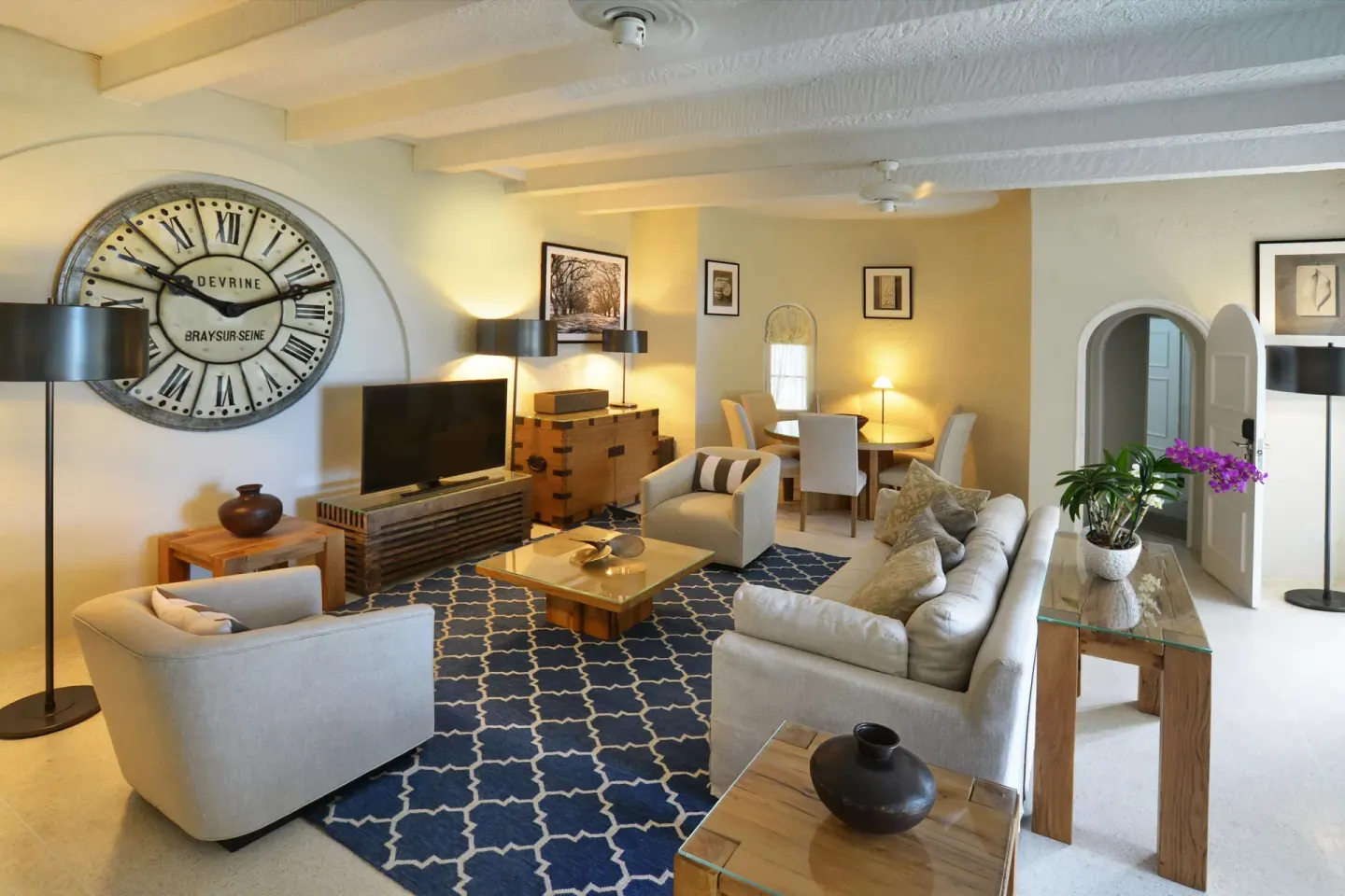 Two-bedroom suite living room with sofa and dining area at Fairmont Royal Pavilion.