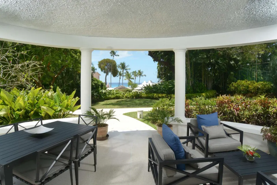 Two-bedroom suite terrace with garden and ocean glimpse at Fairmont Royal Pavilion.