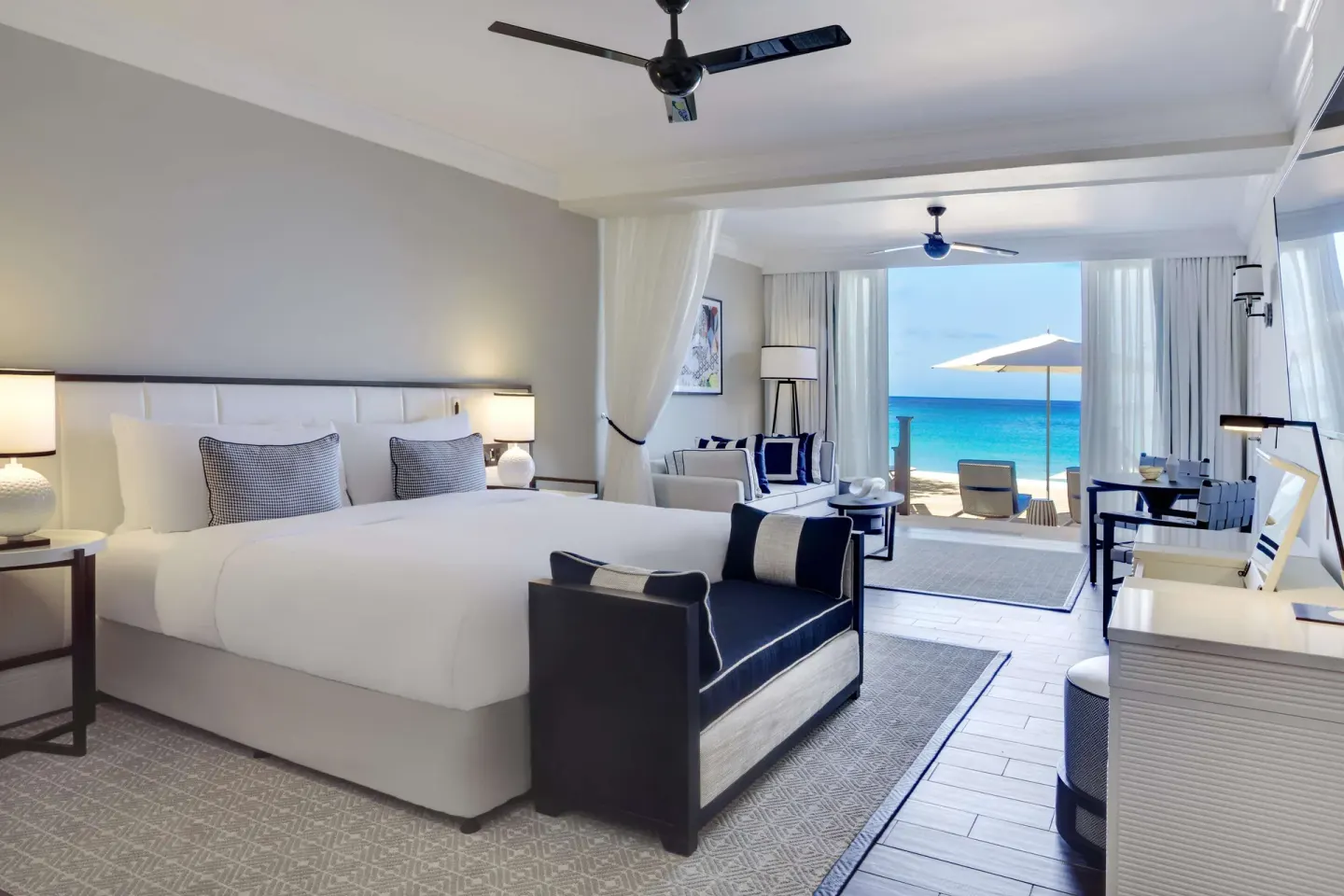 Beachfront suite with king bed and terrace ocean view at Fairmont Royal Pavilion.