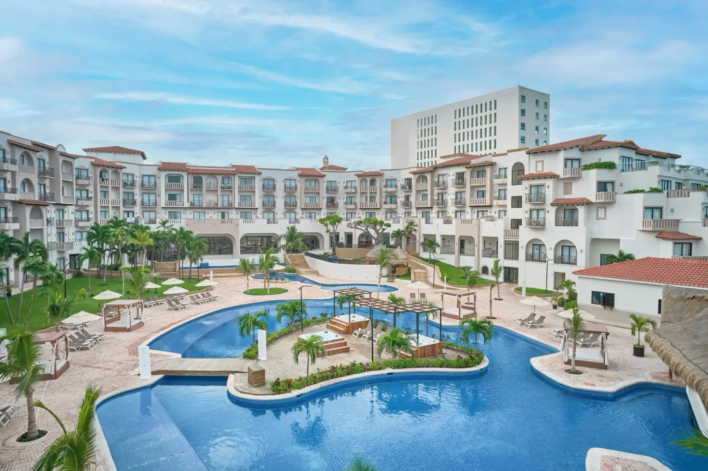 Courtyard pool complex and resort buildings at Fiesta Americana Cancun Villas.