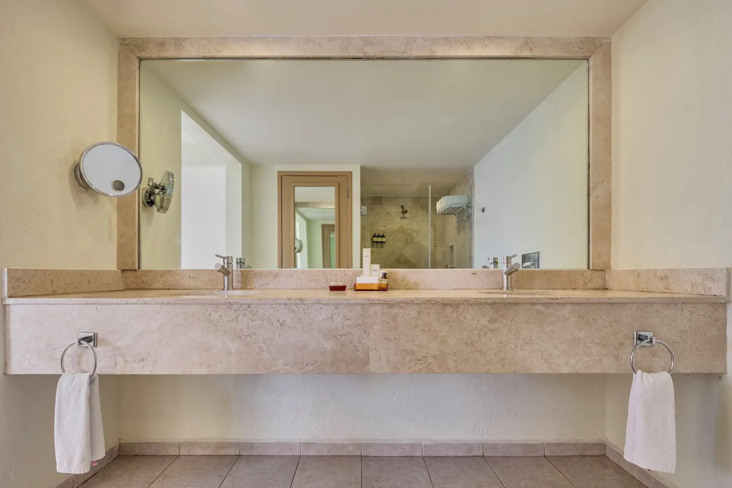 Long bathroom counter with mirror and towels at Fiesta Americana Cancun Villas.