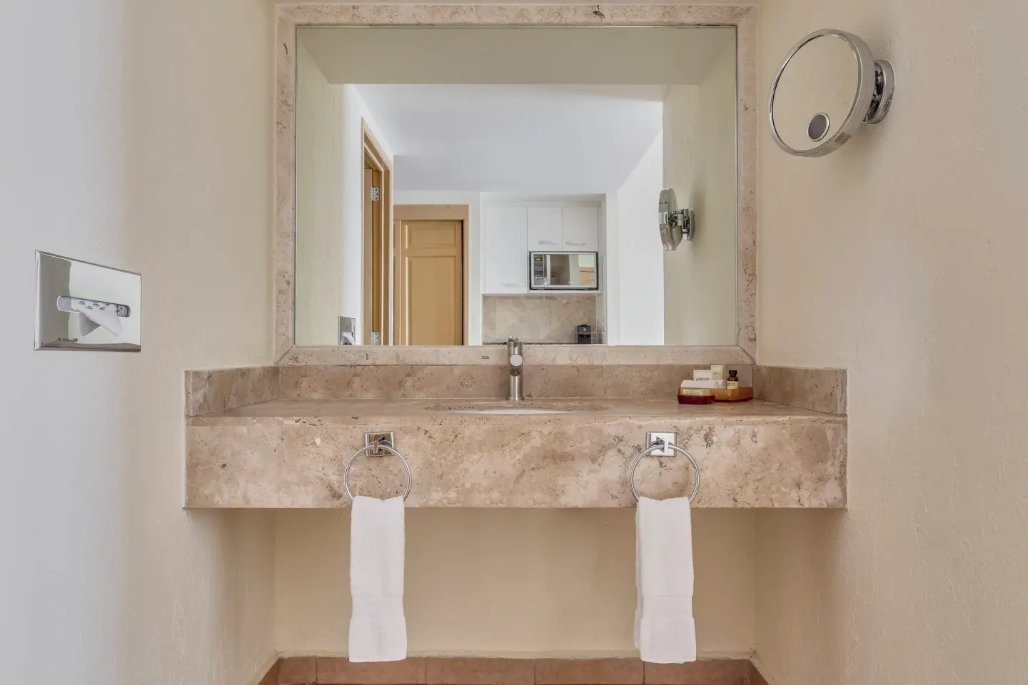 Bathroom vanity with mirror and towels at Fiesta Americana Cancun Villas.