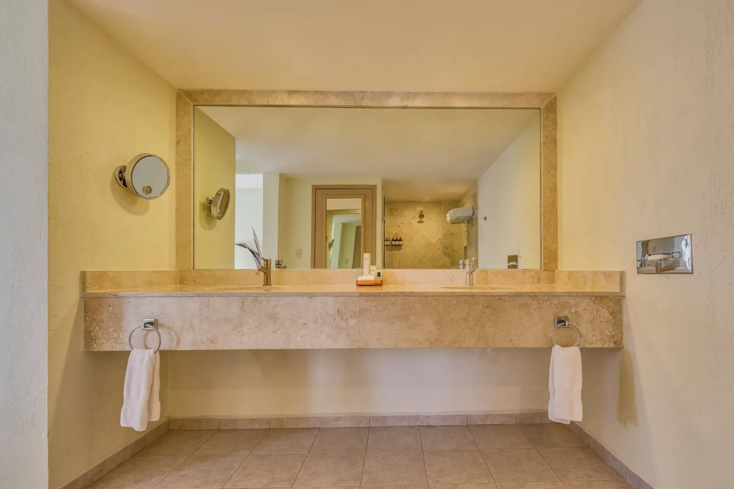Wide bathroom vanity with large mirror at Fiesta Americana Cancun Villas.