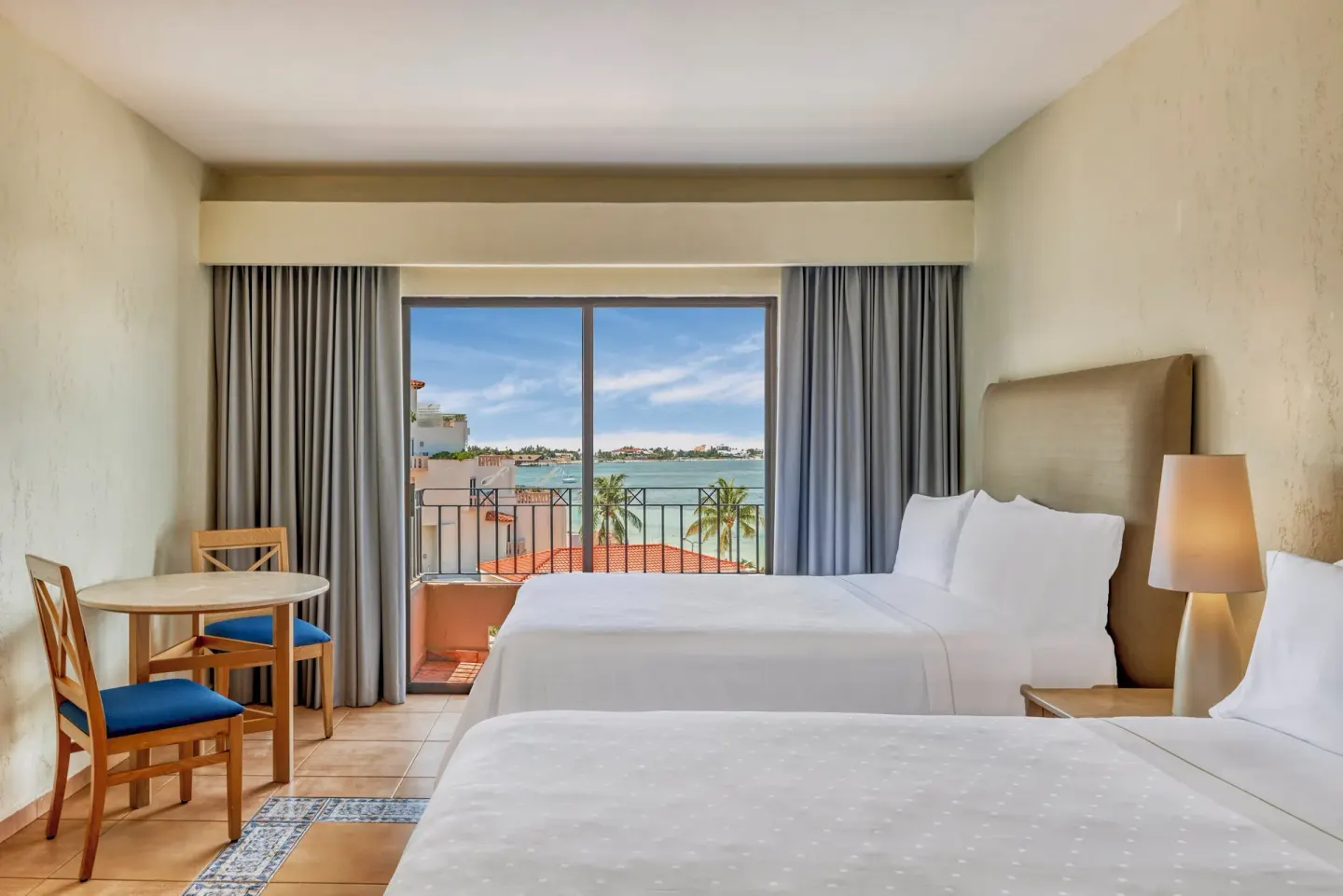 Two-bed guest room with balcony overlooking the lagoon at Fiesta Americana Cancun Villas.
