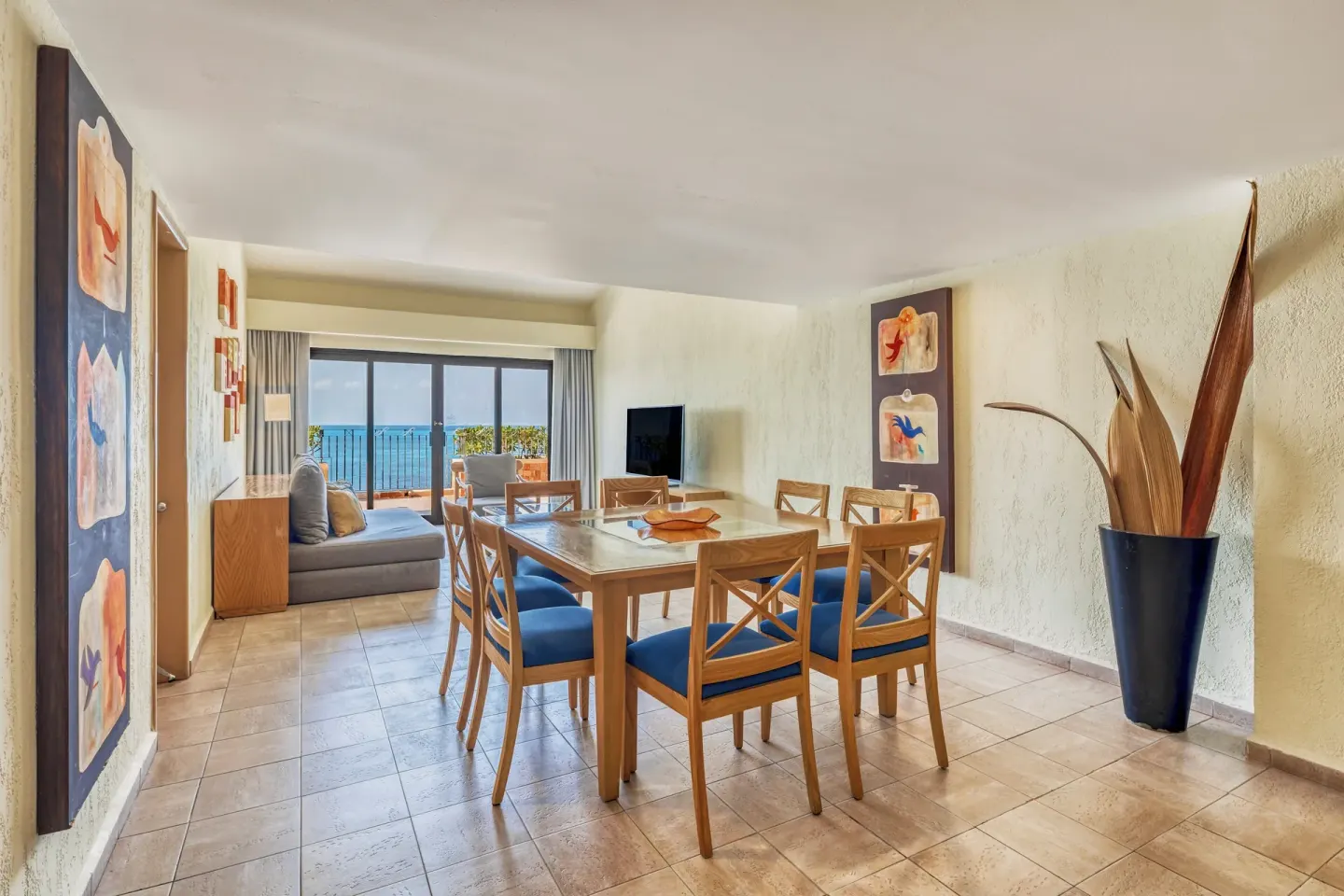 Suite dining and living area with ocean-facing balcony at Fiesta Americana Cancun Villas.