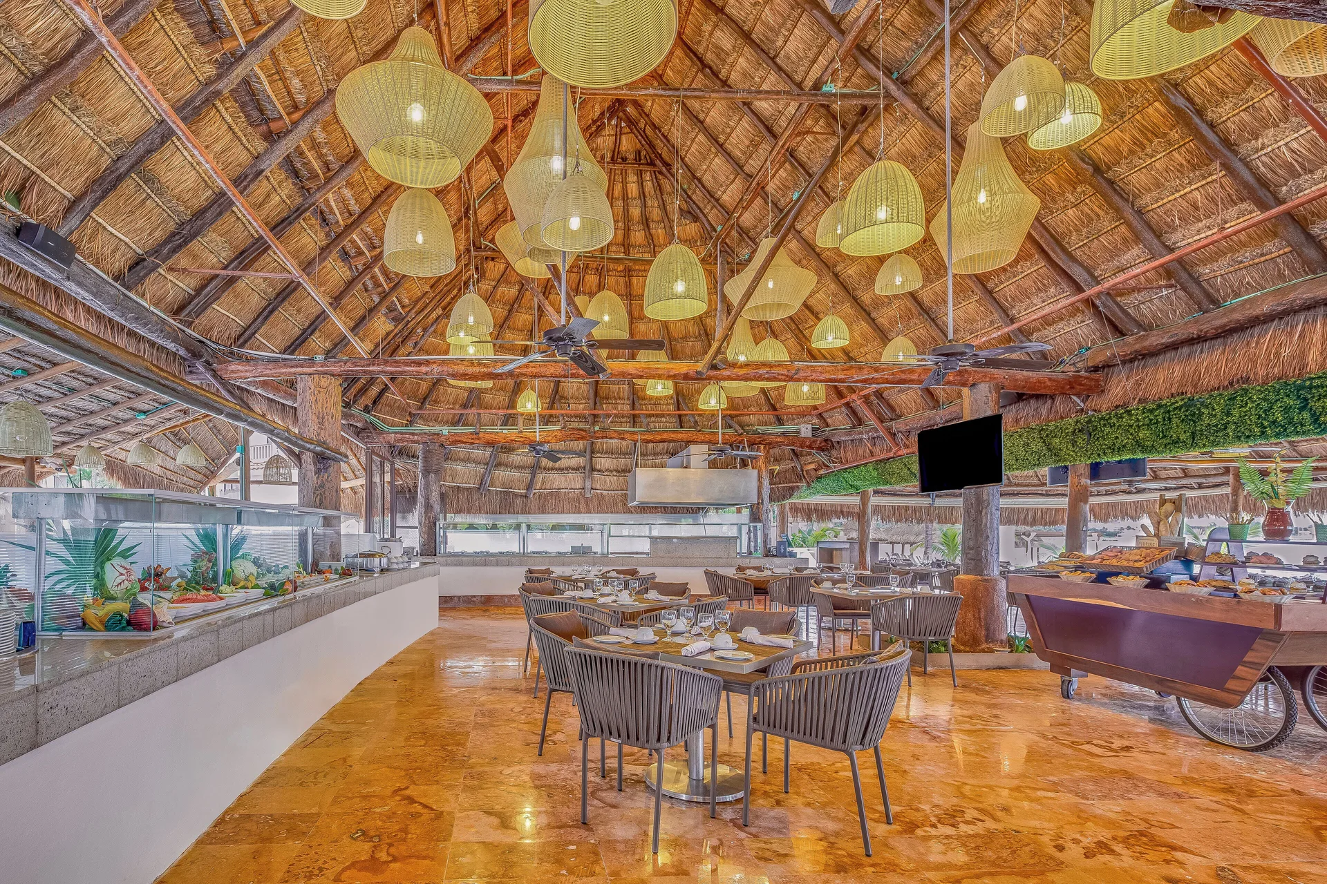 Palapa-style restaurant dining area with buffet stations at Fiesta Americana Cancun Villas.