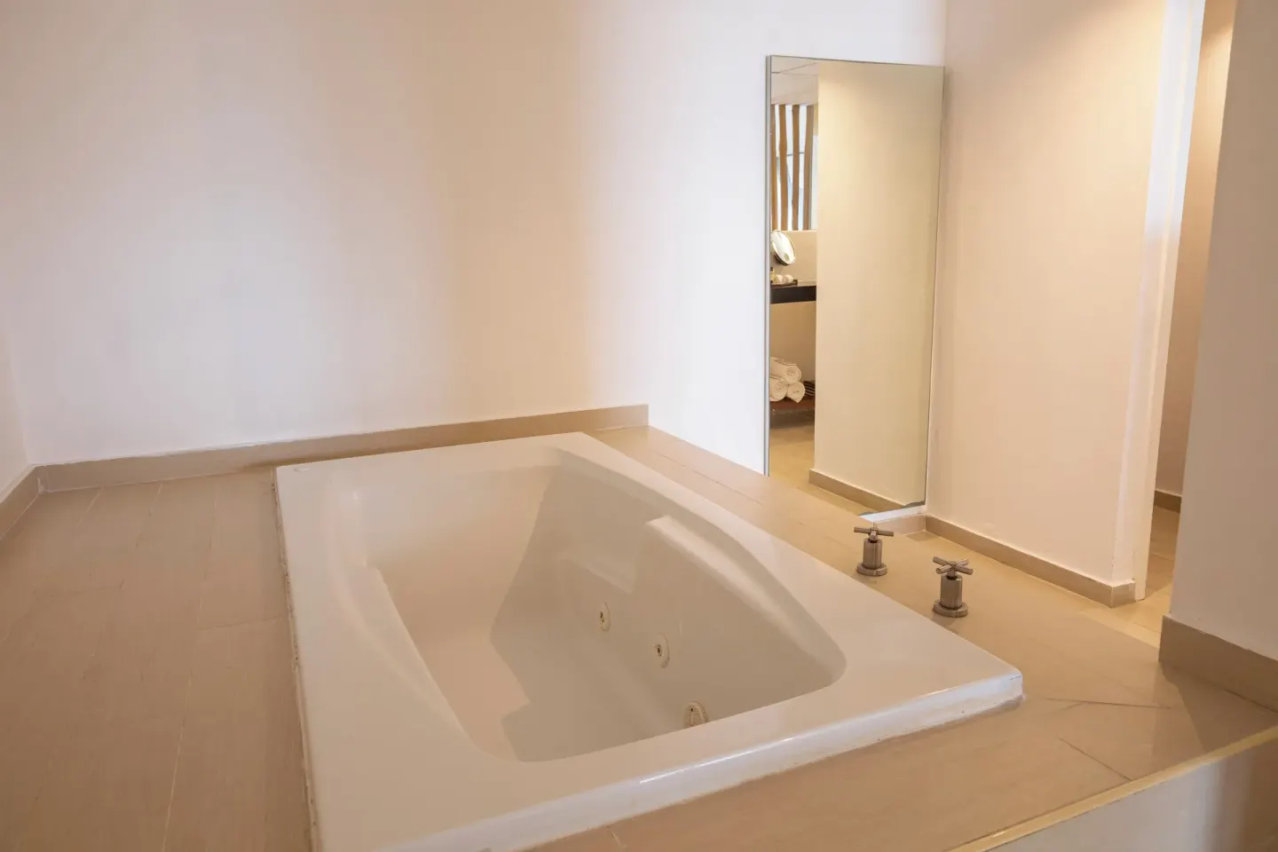 In-room jetted tub beside a mirror at Fiesta Americana Cozumel.