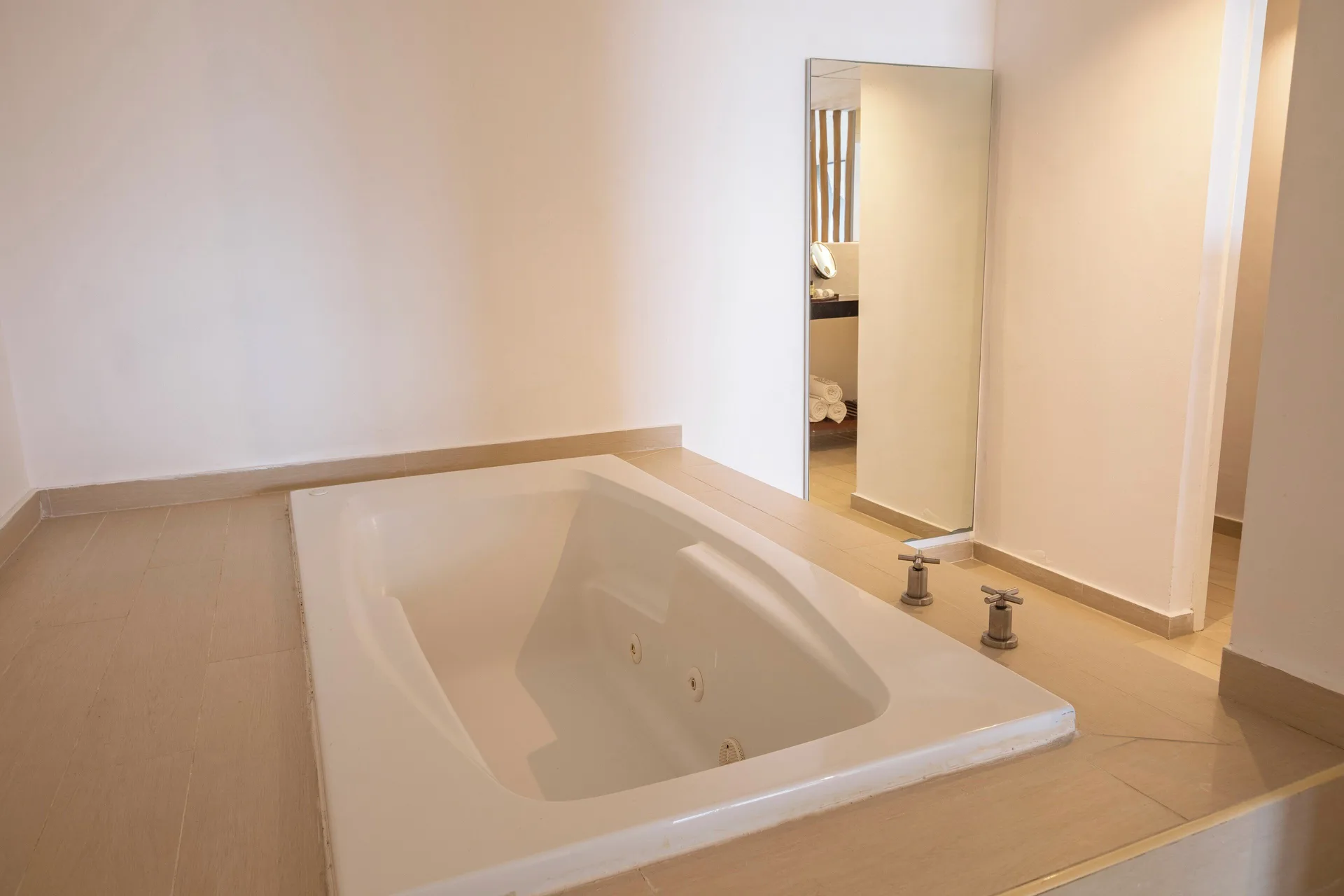 In-room jetted tub beside a mirror at Fiesta Americana Cozumel.