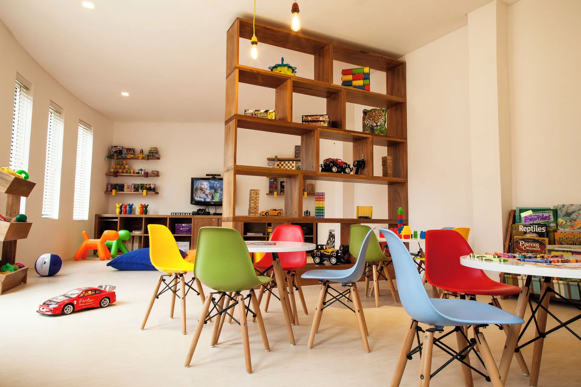 Kids club playroom with colorful chairs and toys at Fiesta Americana Cozumel.