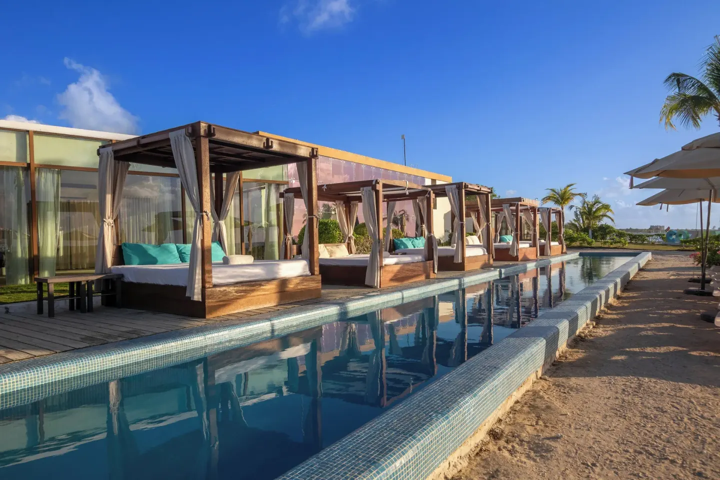 Poolside cabanas line a narrow reflecting pool at Fiesta Americana Cozumel.