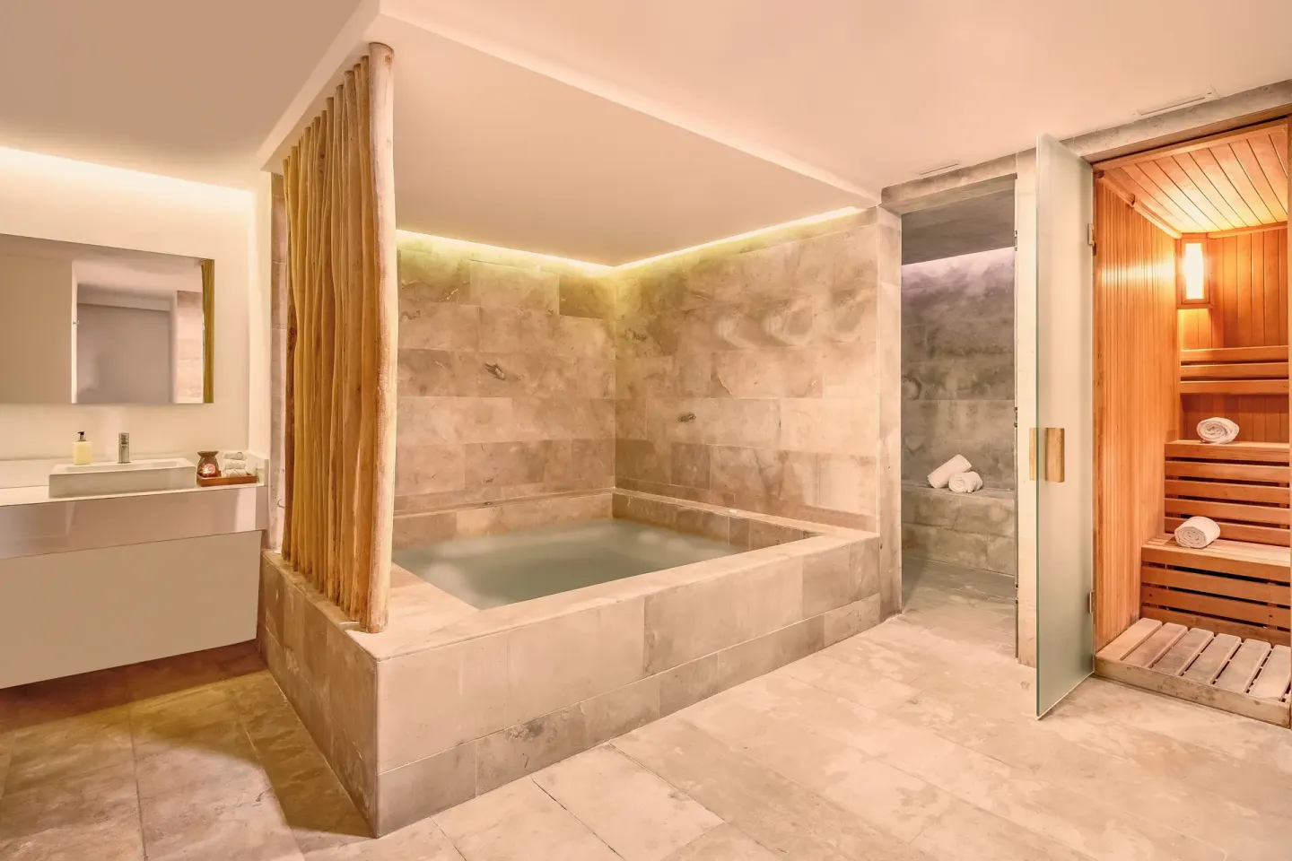 Spa hydrotherapy pool, shower area, and wood sauna at Fiesta Americana Cozumel.
