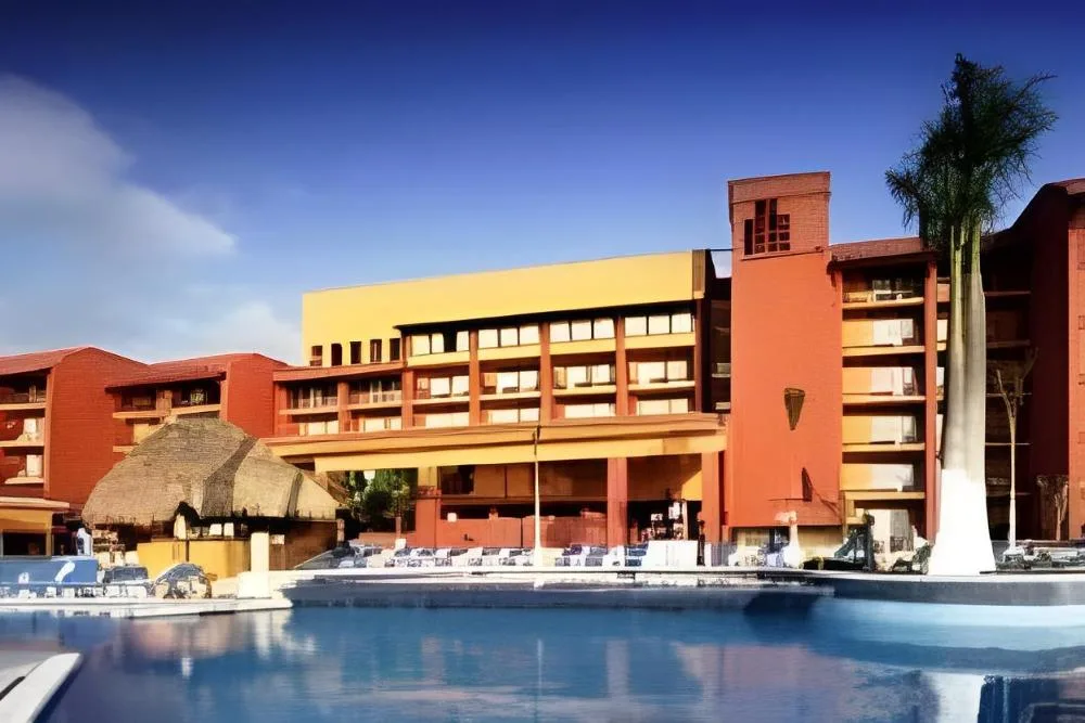 3 Bedrooms Family Suite exterior building and pool area at Fiesta Americana Cozumel.